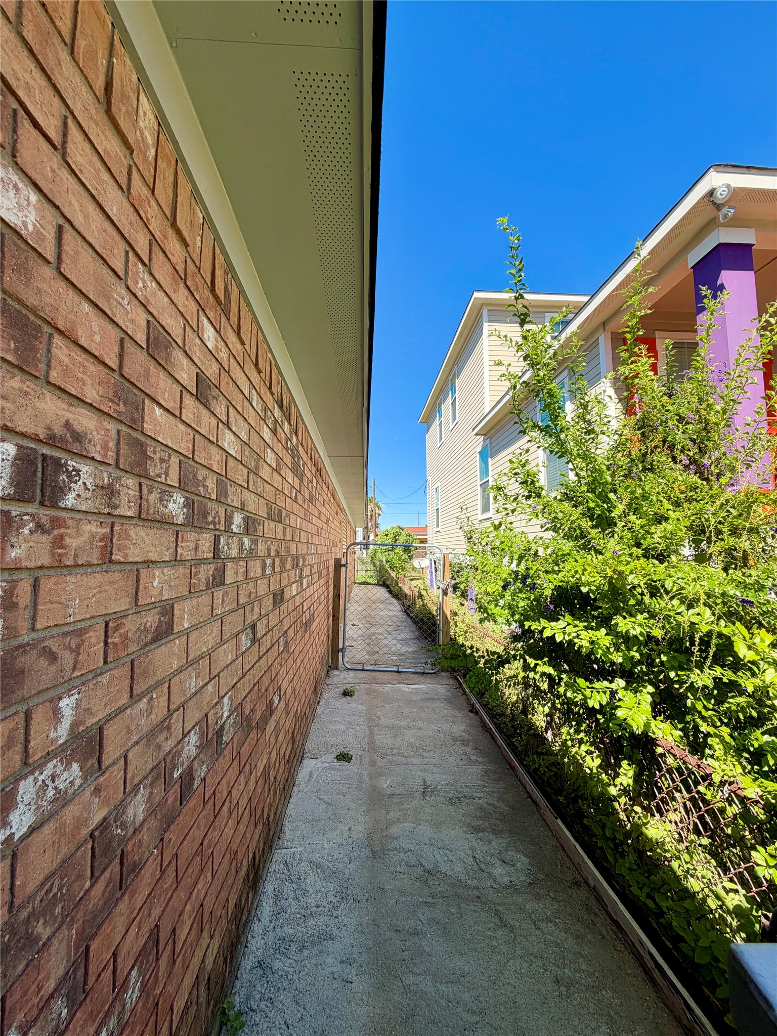 Another view of the east side of the home. Fully fenced back yard.