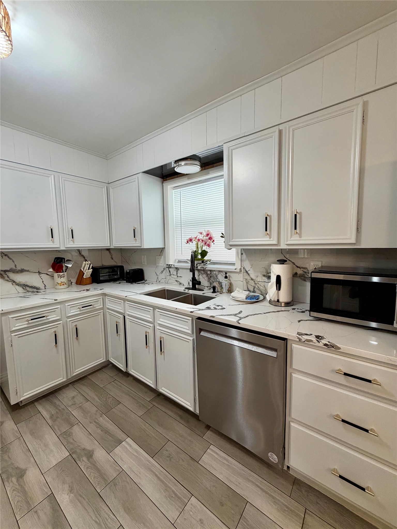 Stainless appliances and lovely kitchen window above the sink.