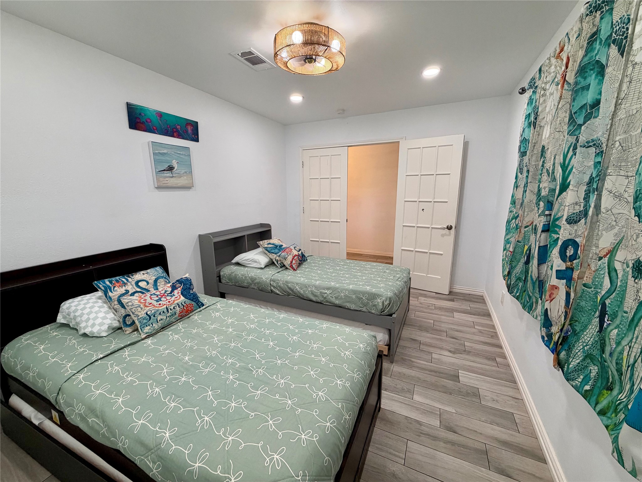 Guest bedroom 4 with double French doors and custom ceiling fan