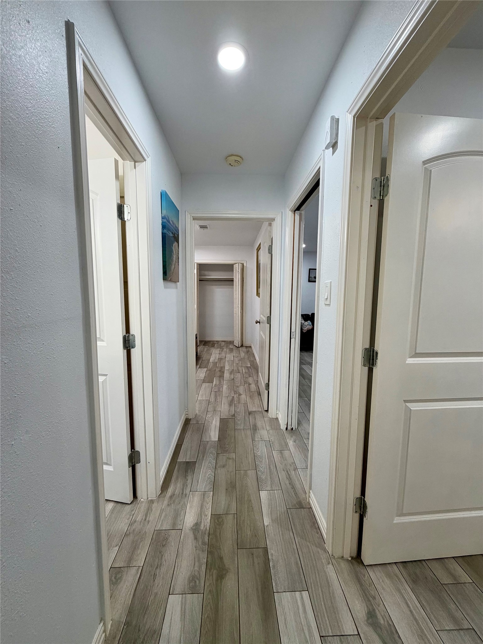 Hallway connecting the primary bedroom, 2 of the guest bedrooms and guest bathroom