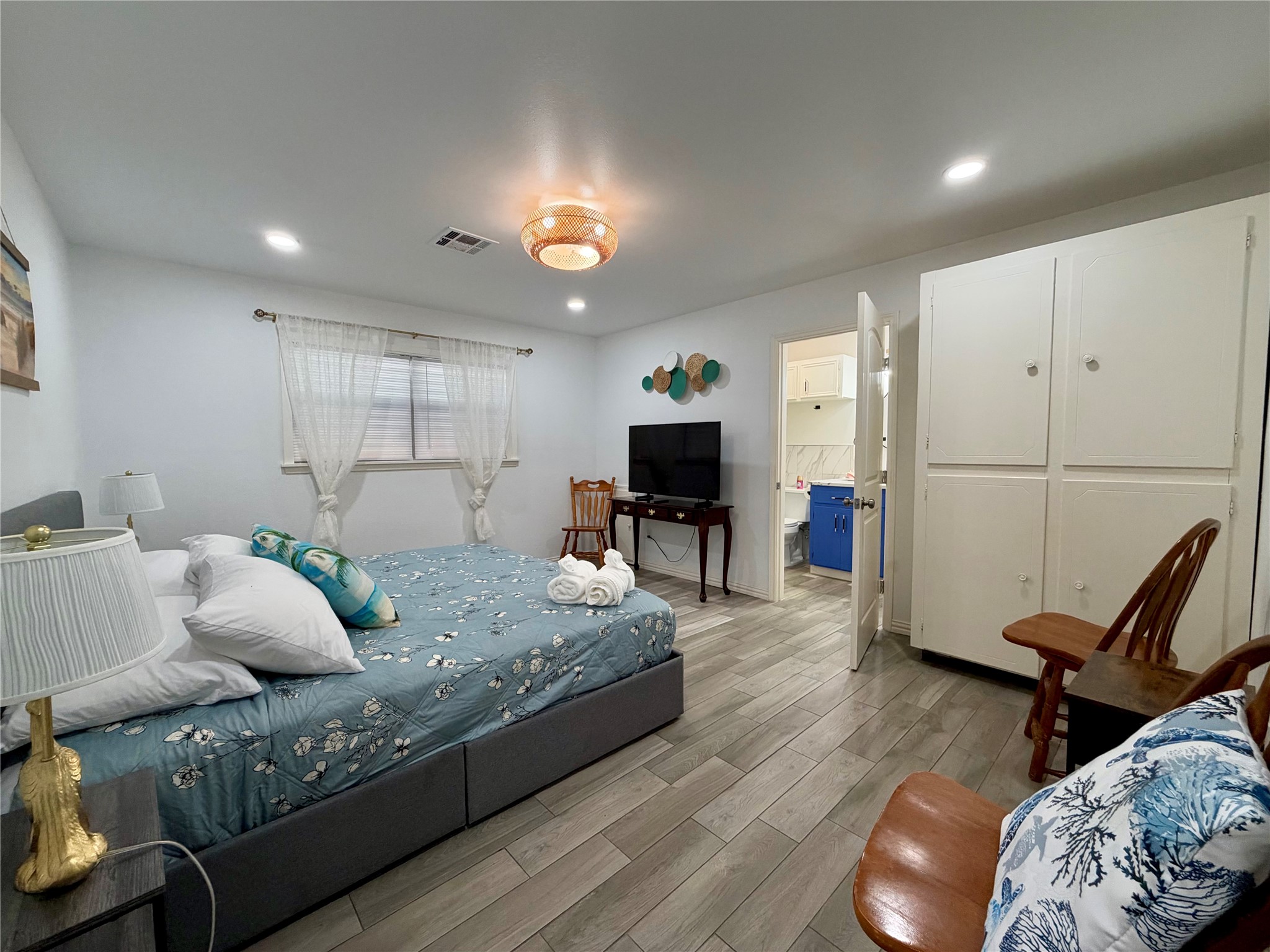 Primary bedroom with built-in storage. Ensuite bathroom to the right.