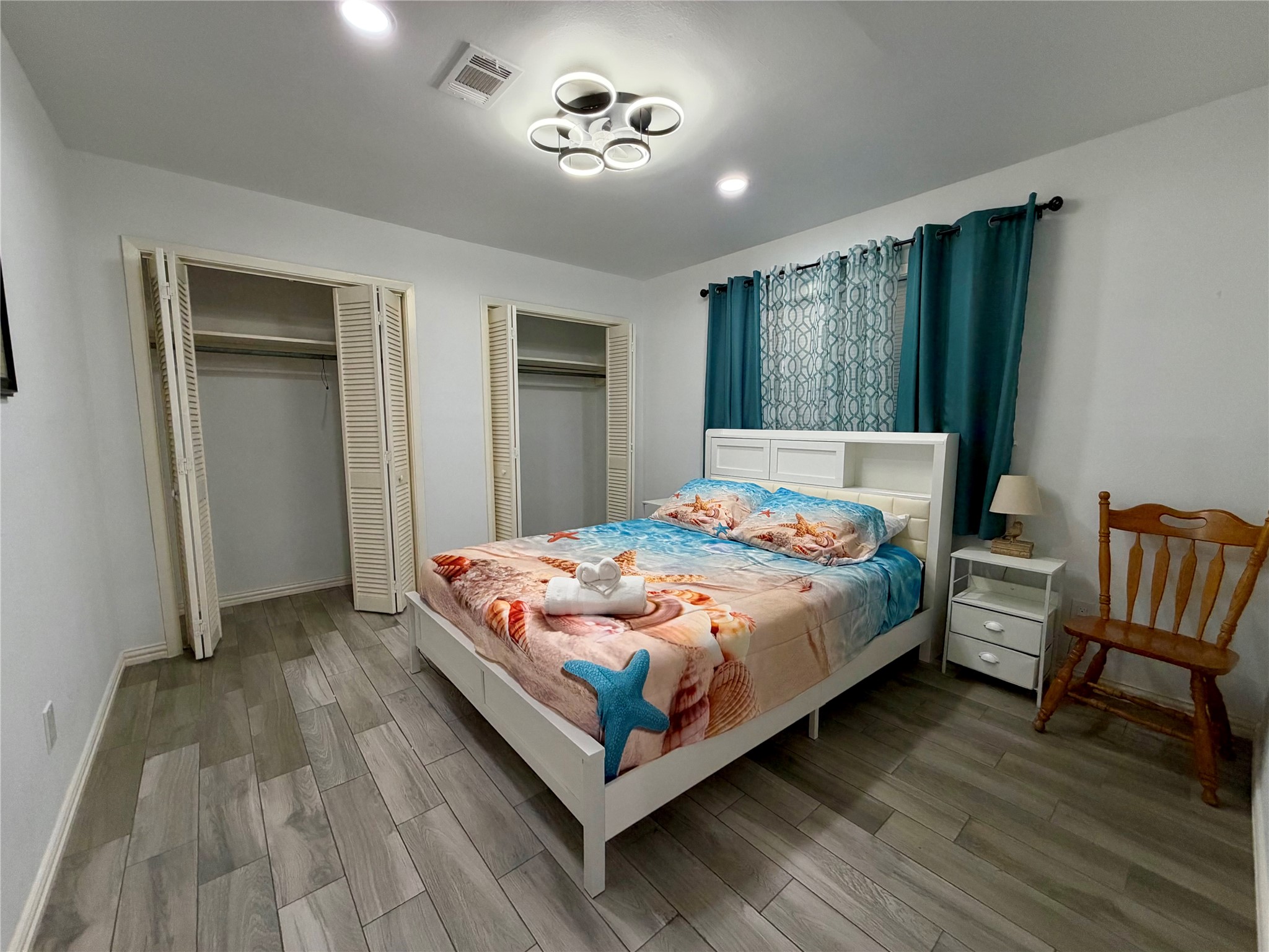 Guest bedroom 3, also with double closets and custom ceiling fan light fixture.