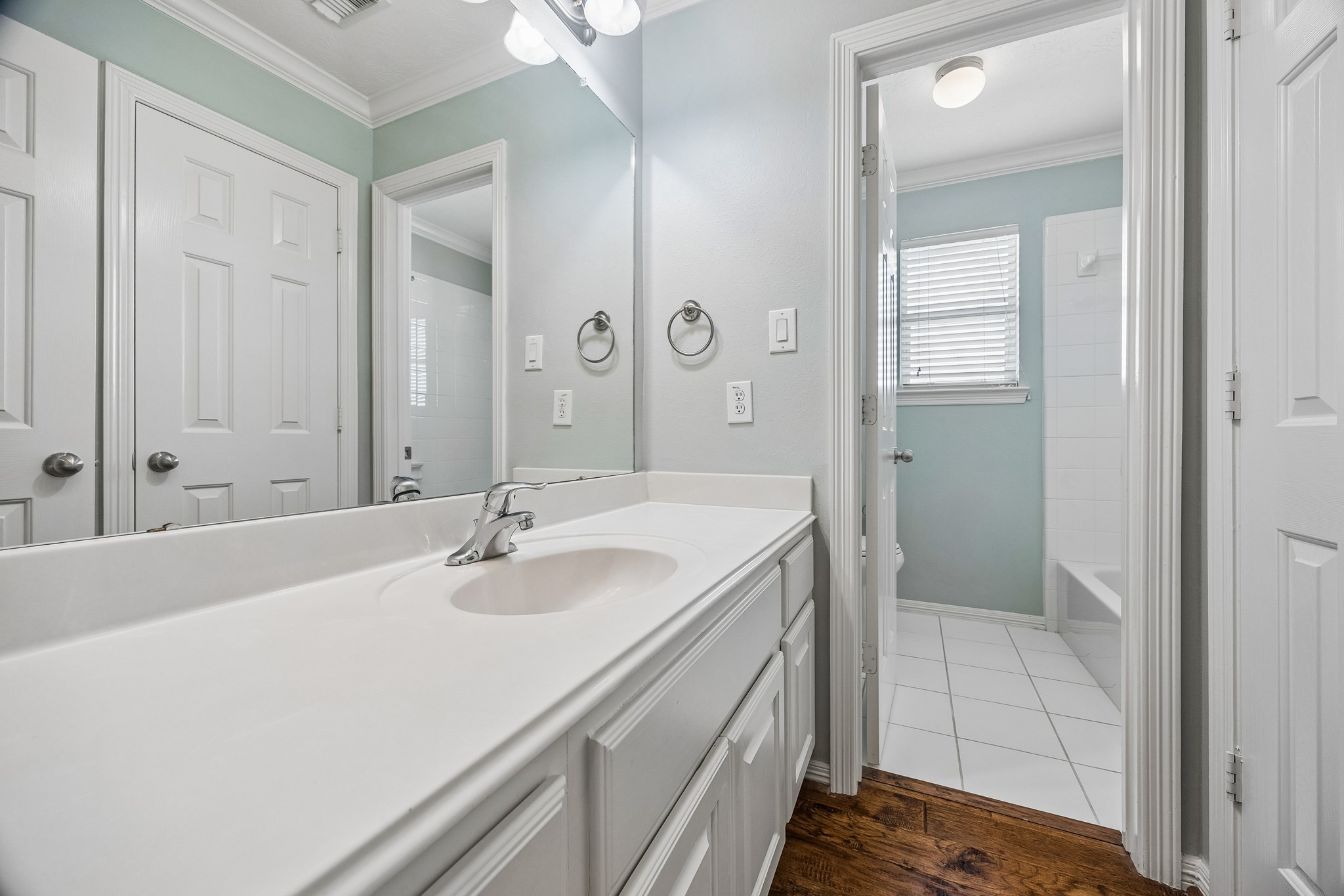 A bright, functional bathroom with convenient vanity storage for everyday essentials.