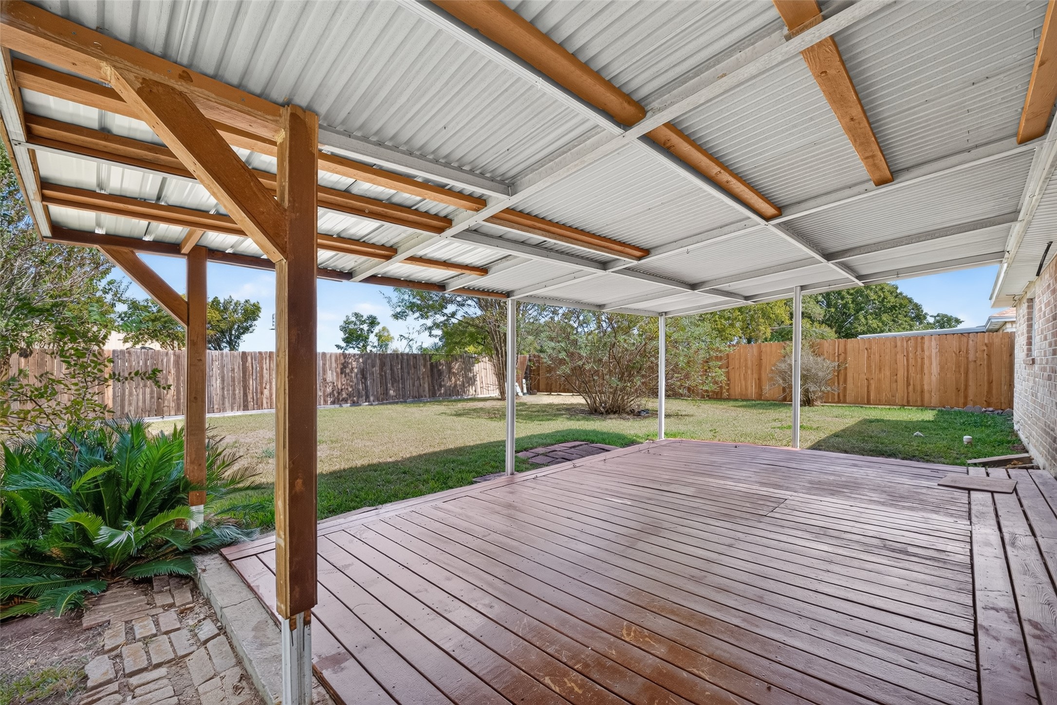 Huge covered back patio with a spacious backyard space too!