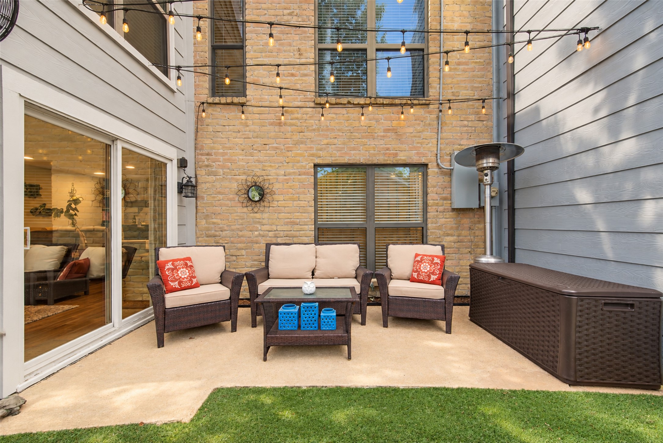 Outdoor seating area with decorative lighting and courtyard access.