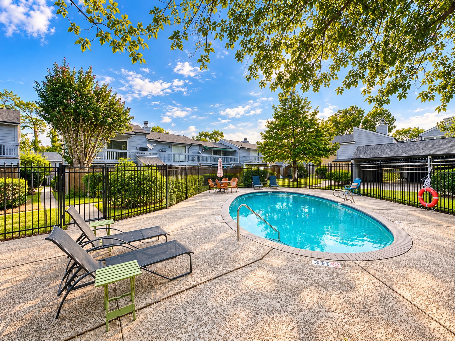 Additional community pool with spacious sundeck and landscaped surroundings