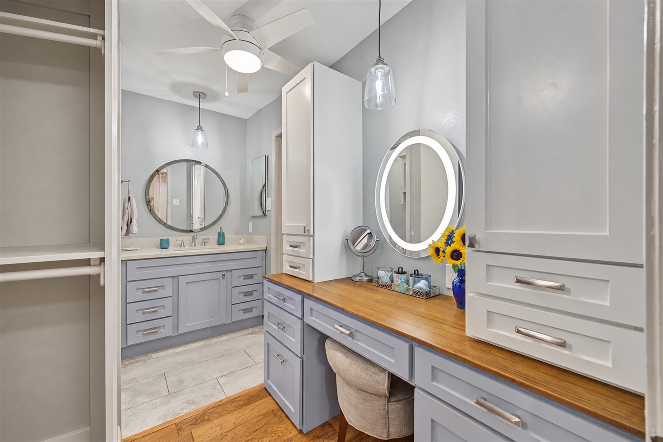 Primary dressing area with custom cabinetry and illuminated mirror. Primary dressing area with custom cabinetry and illuminated mirror.