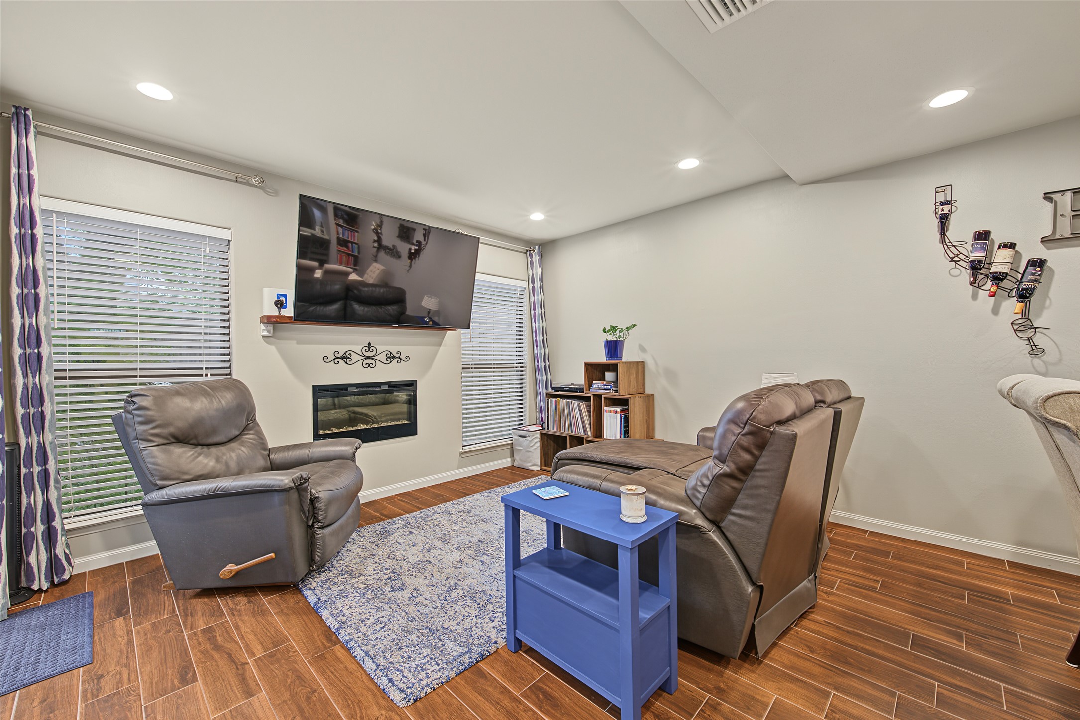 Inviting living room with fireplace and wood looking tile flooring Inviting living room with fireplace and wood looking tile flooring