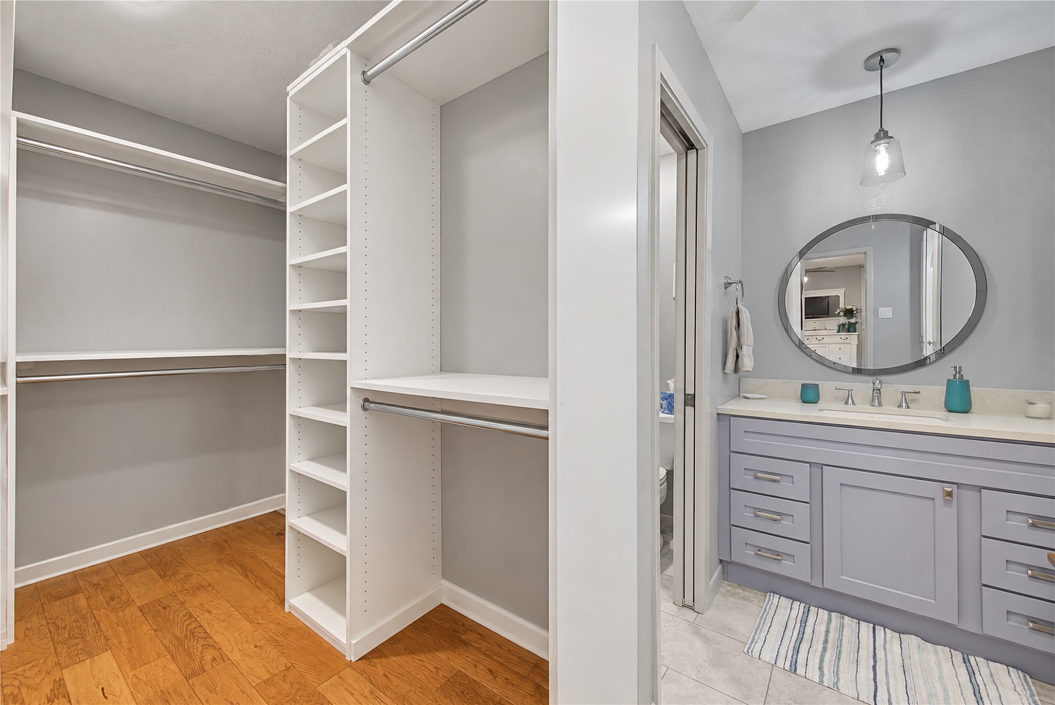 Primary bathroom vanity adjoining spacious walk-in closet. Primary bathroom vanity adjoining spacious walk-in closet.