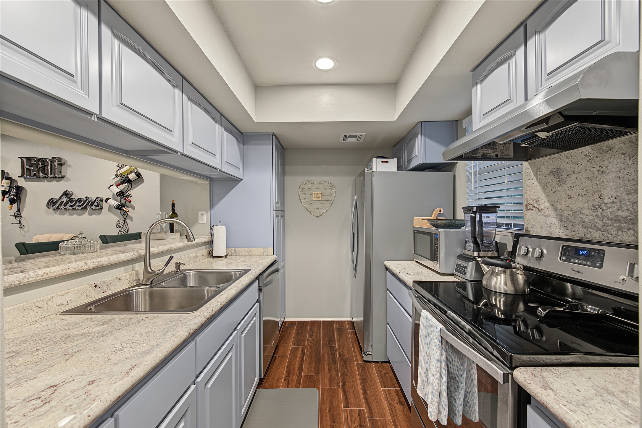 Kitchen with granite countertops, stainless appliances and breakfast bar.