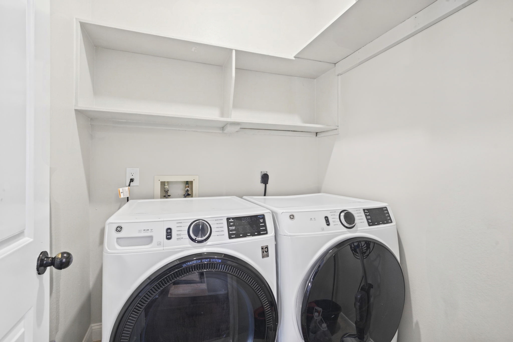 Enjoy the convenience of a dedicated utility room with the washer and dryer included. Built-in shelving provides additional storage space to help keep laundry essentials and household items organized, making everyday chores a little easier.