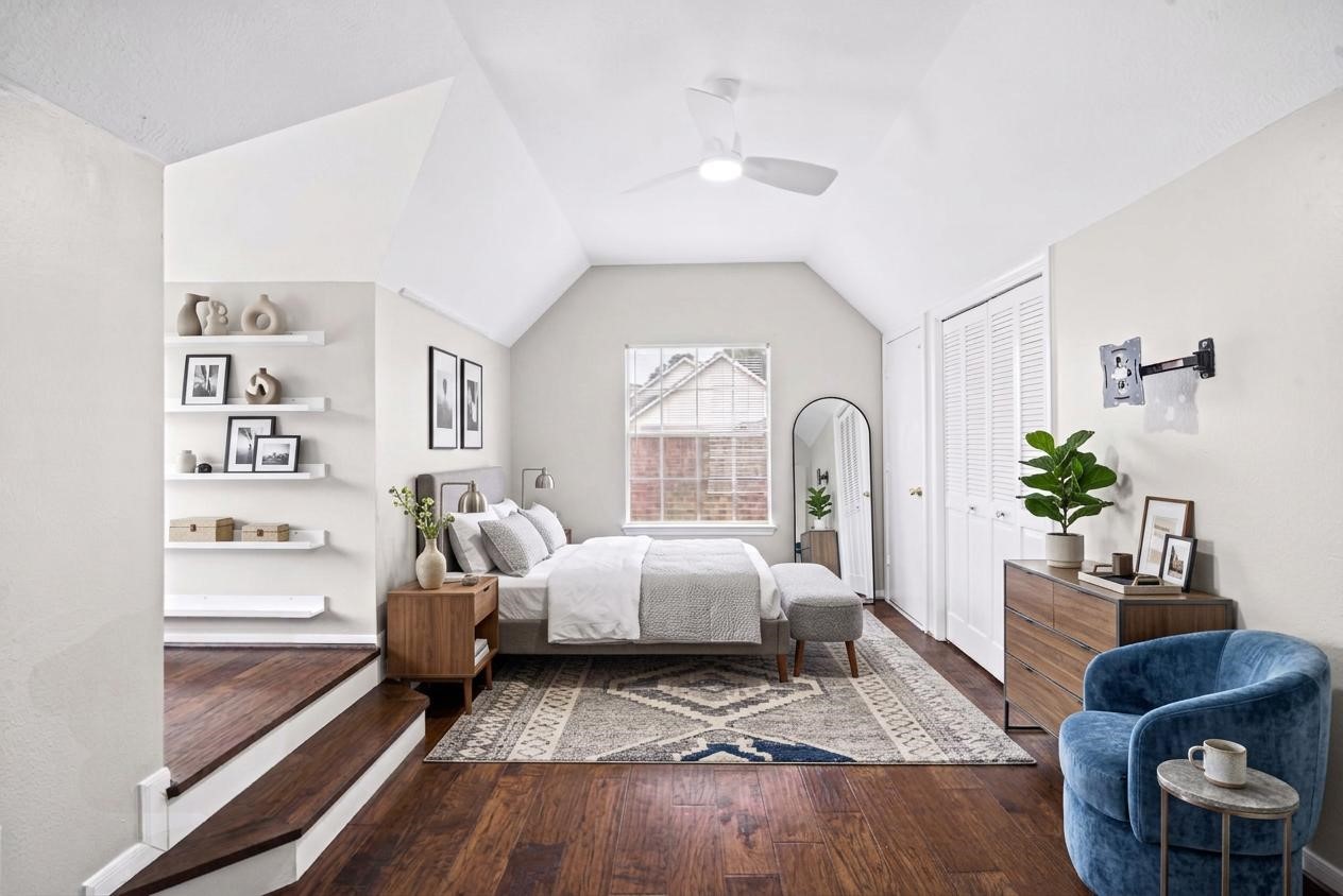One of three secondary bedrooms upstairs, this inviting space features beautiful engineered hardwood floors, windows that fill the room with natural light, and a ceiling fan for added comfort. An elevated flex area provides the perfect spot for a desk, cozy reading nook, study space, or creative retreat, adding extra versatility to this charming bedroom.