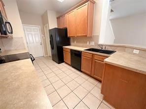 Kitchen with black appliance are included. 2 pantry!