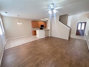 Entry into family room with recently installed wood floors and fresh paint. Powder/guest restroom on first floor