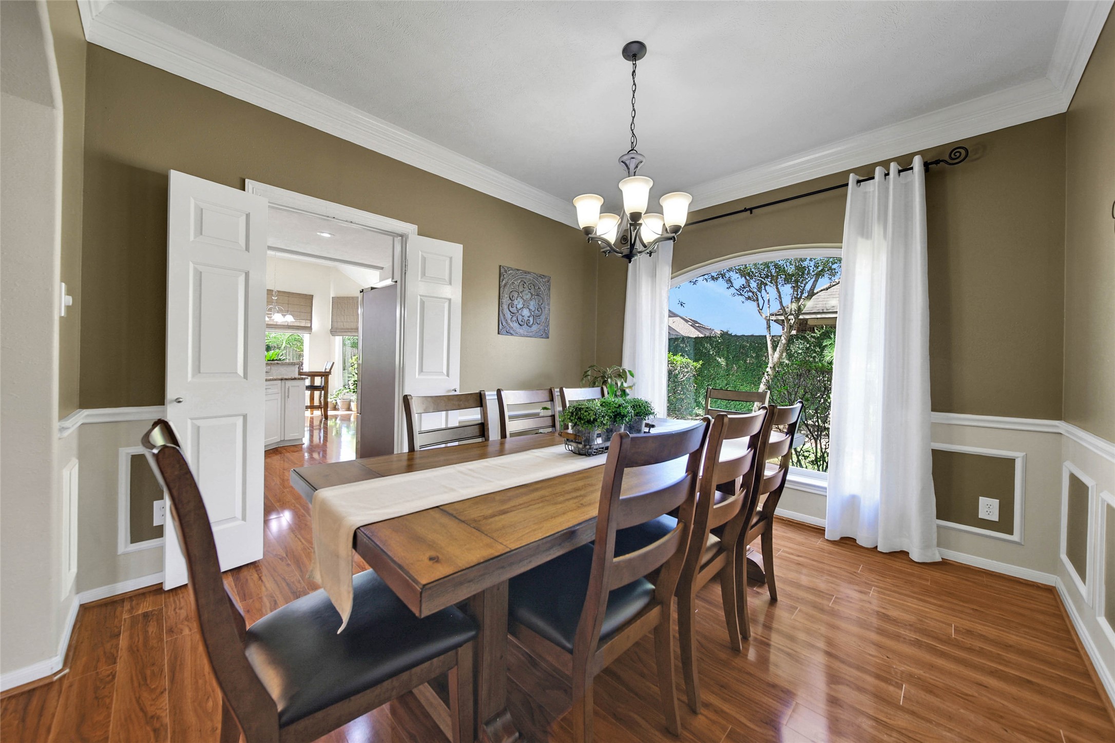 Continuing a little further into the home on the right, the large dining room has beautiful decorative details. The crown and chair moldings add to the charm of this home that you just don't find everywhere.
