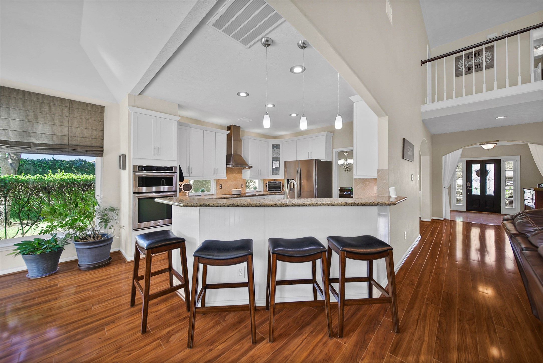 The functional breakfast bar is an easy spot for extra seating!