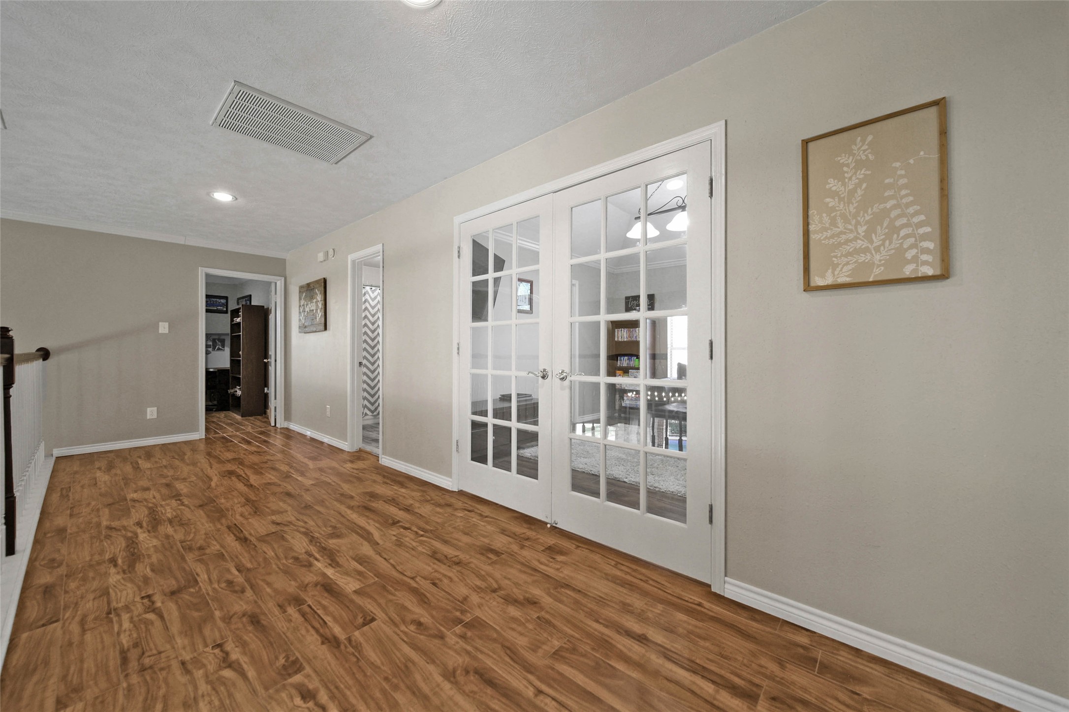 Upstairs you will find nice and wide hallway that leads to three bedrooms and a gameroom with double doors.
