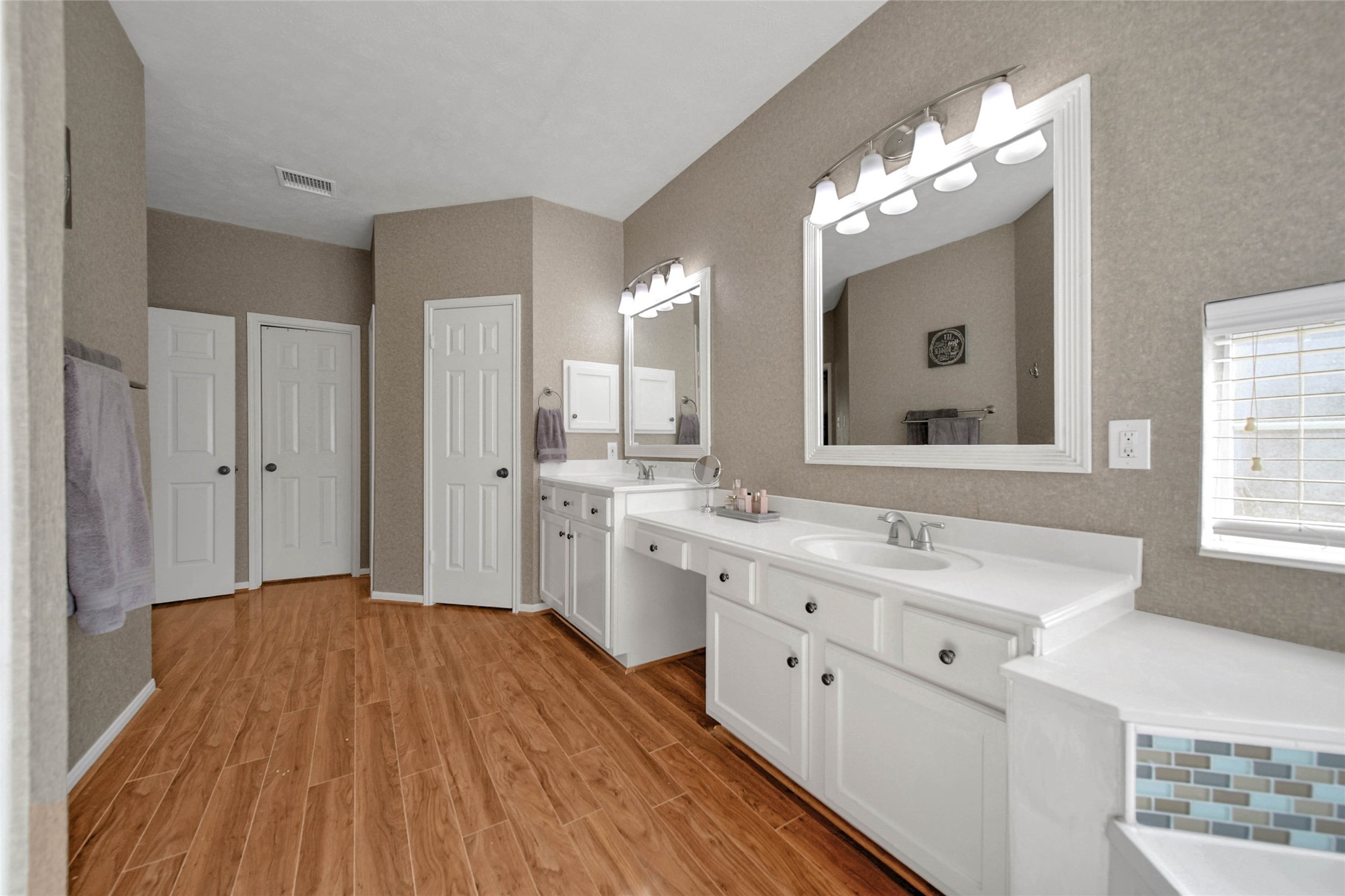 Primary bathroom with two separate sinks as well as a vanity area!