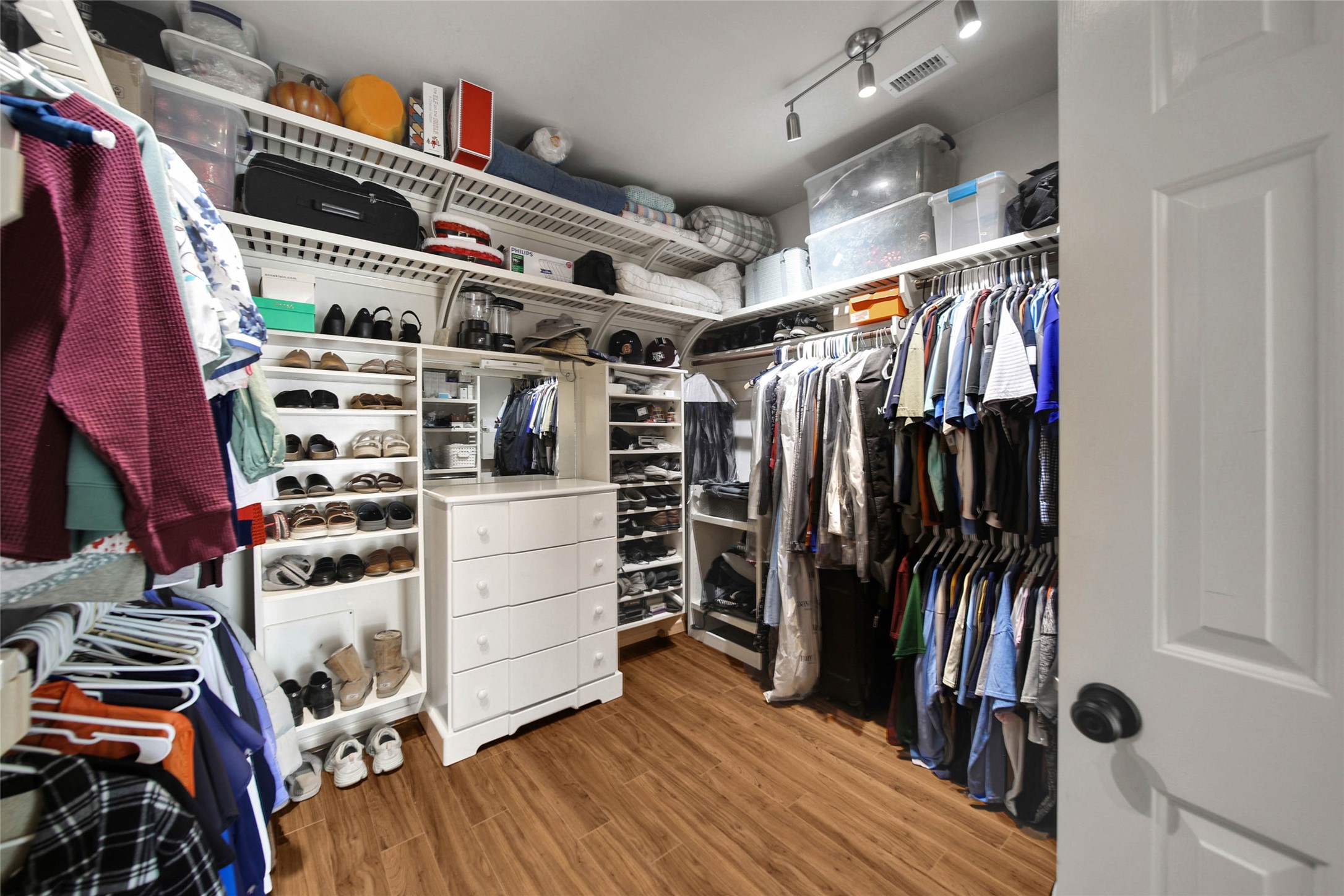The primary walk-in closet has a well thought out space for everything.