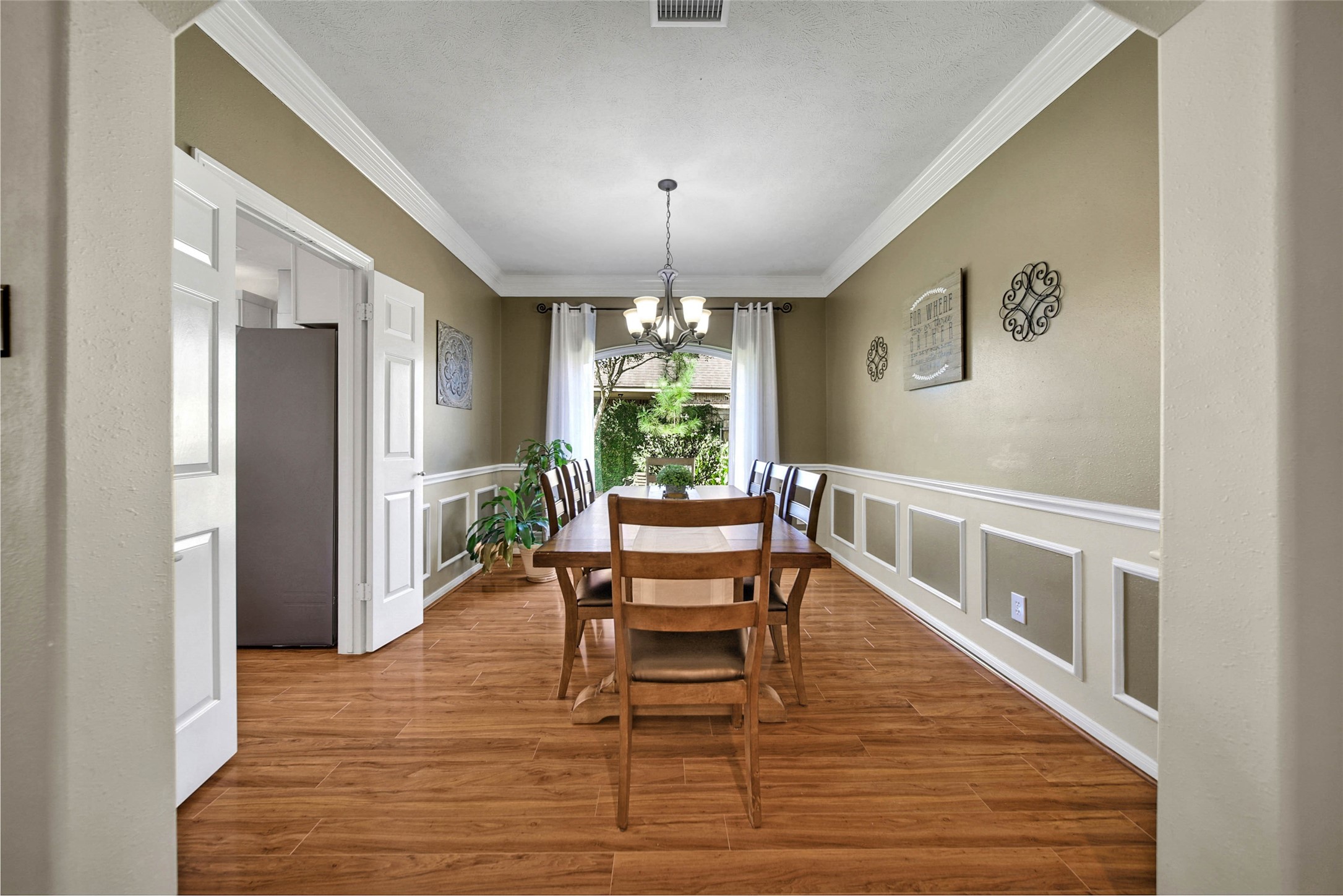Continuing a little further into the home on the right, the large dining room has beautiful decorative details.