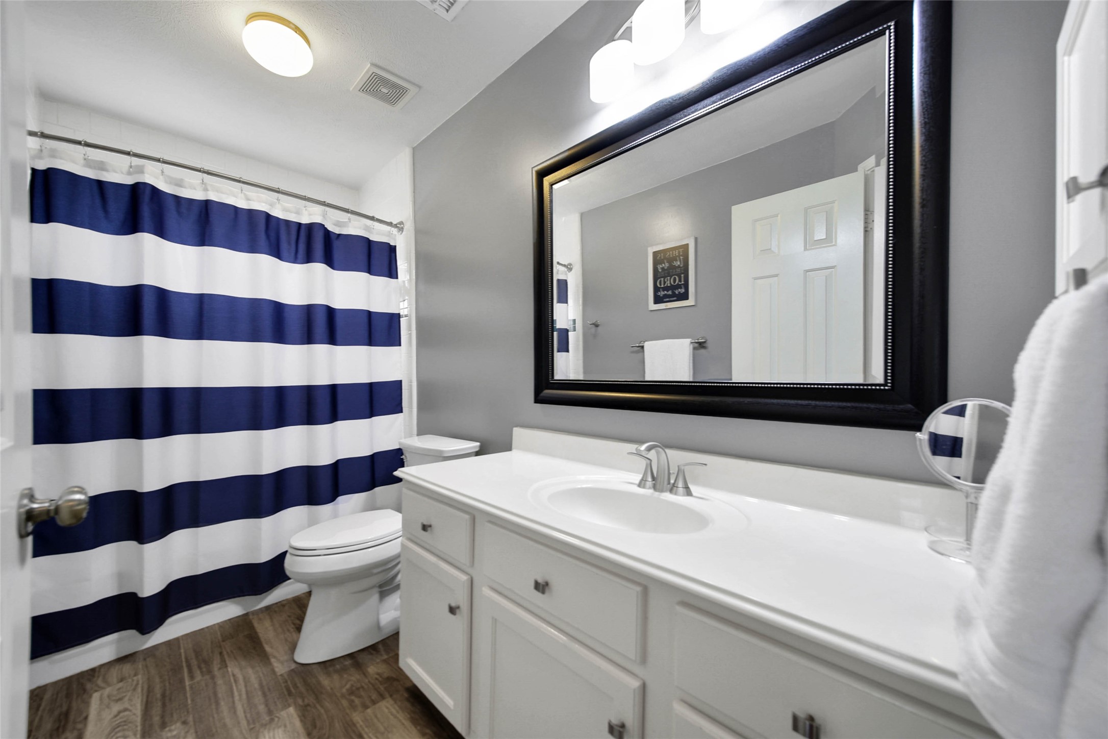 Bathroom number two has ample counter space and a shower/tub combo.