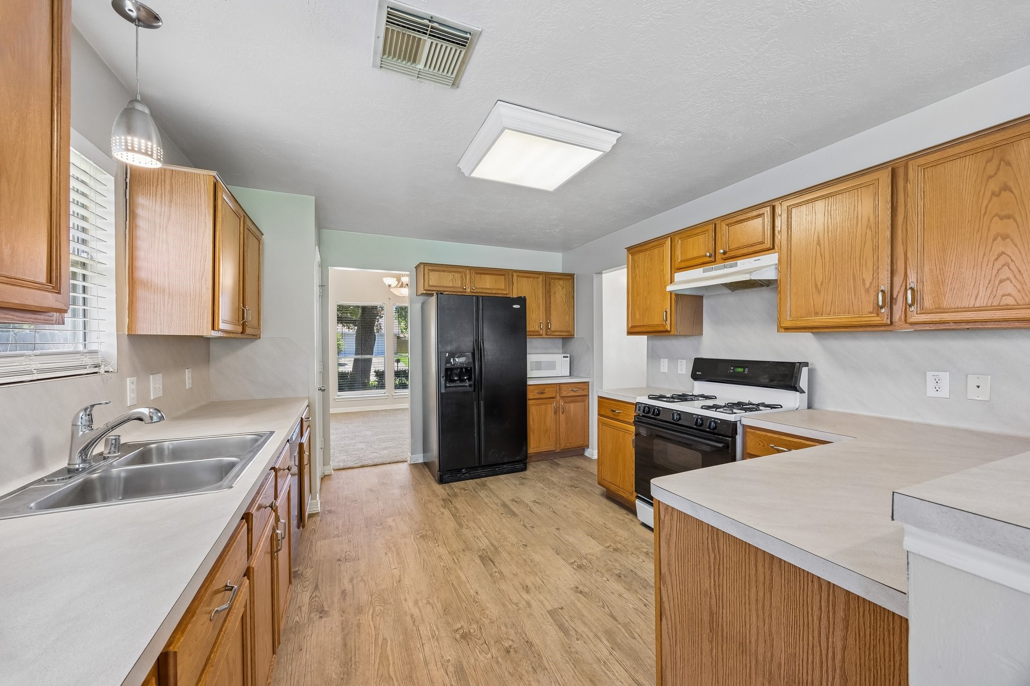 Kitchen has lots of natural light clean and lots of storage.