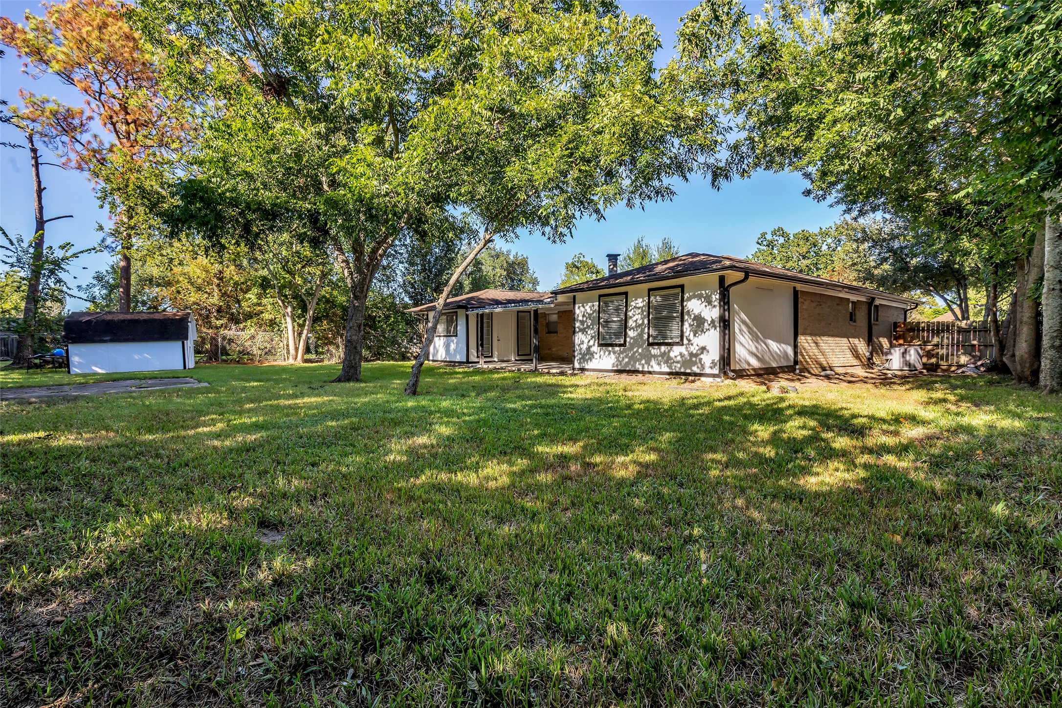 Room to garden, play or entertain in the expansive backyard, framed by mature trees.