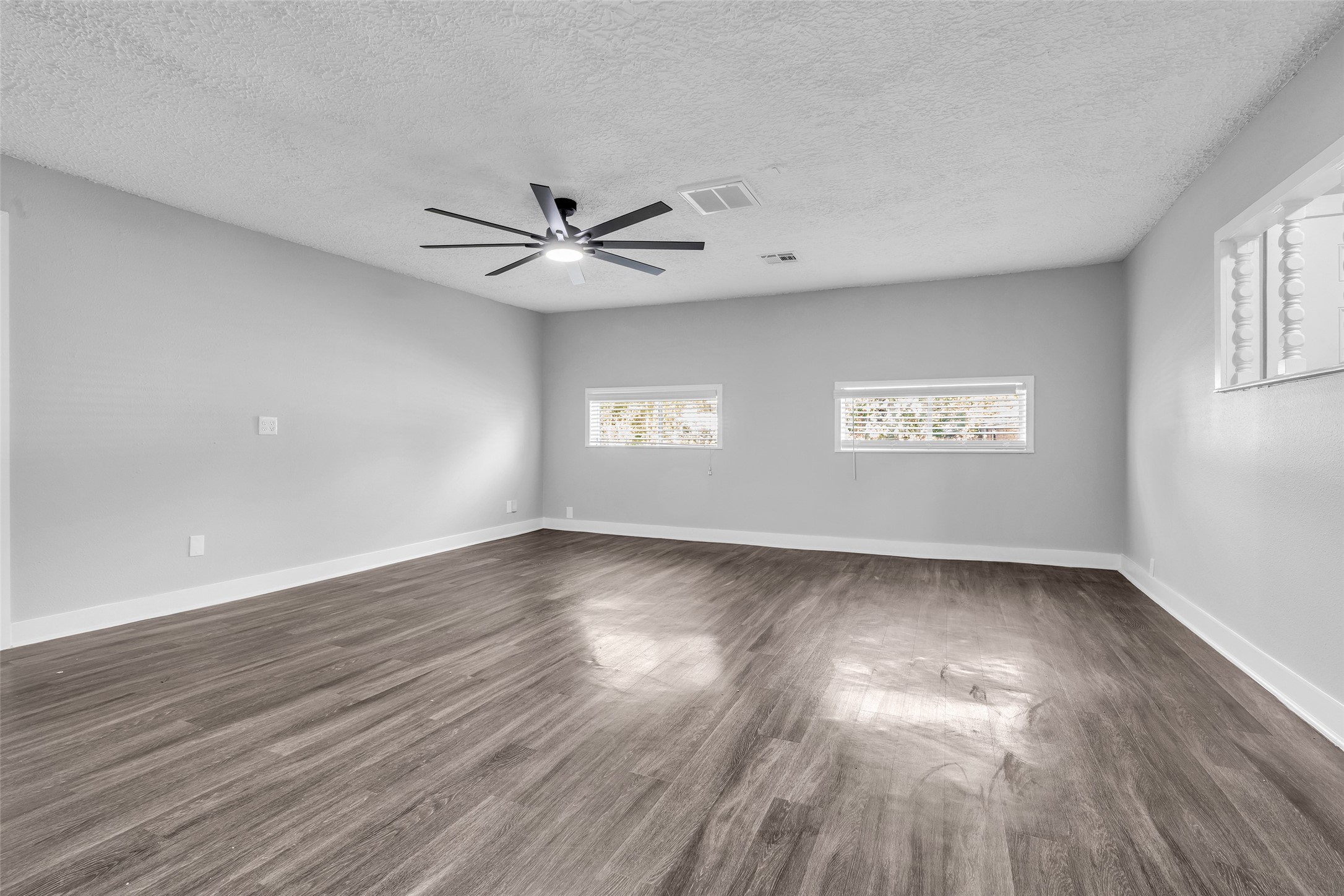 Flexible space for a hobby room, office or media room, with a modern ceiling fan overhead.