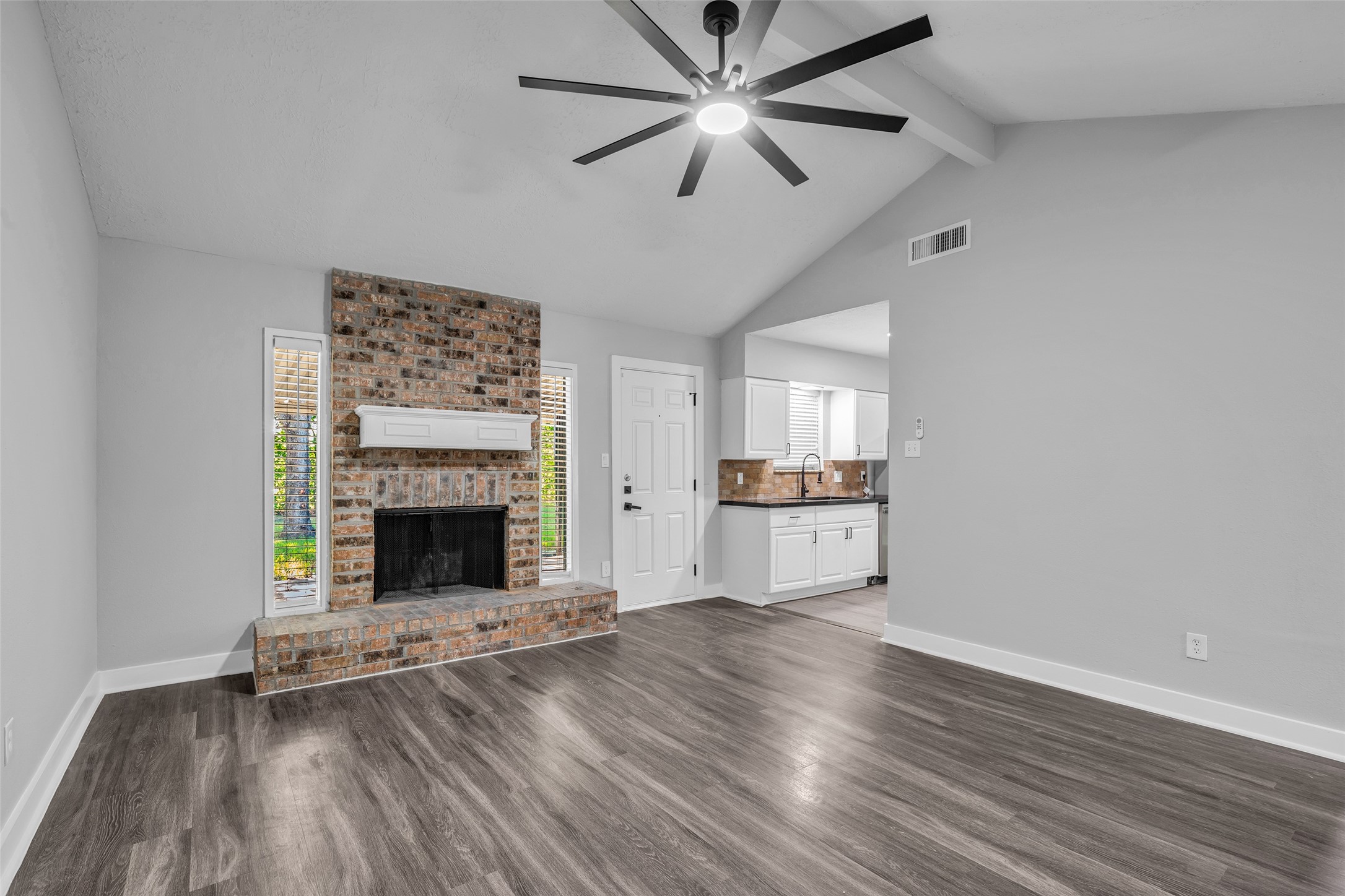 A cozy spot to unwind by the fireplace, with the kitchen just steps away.