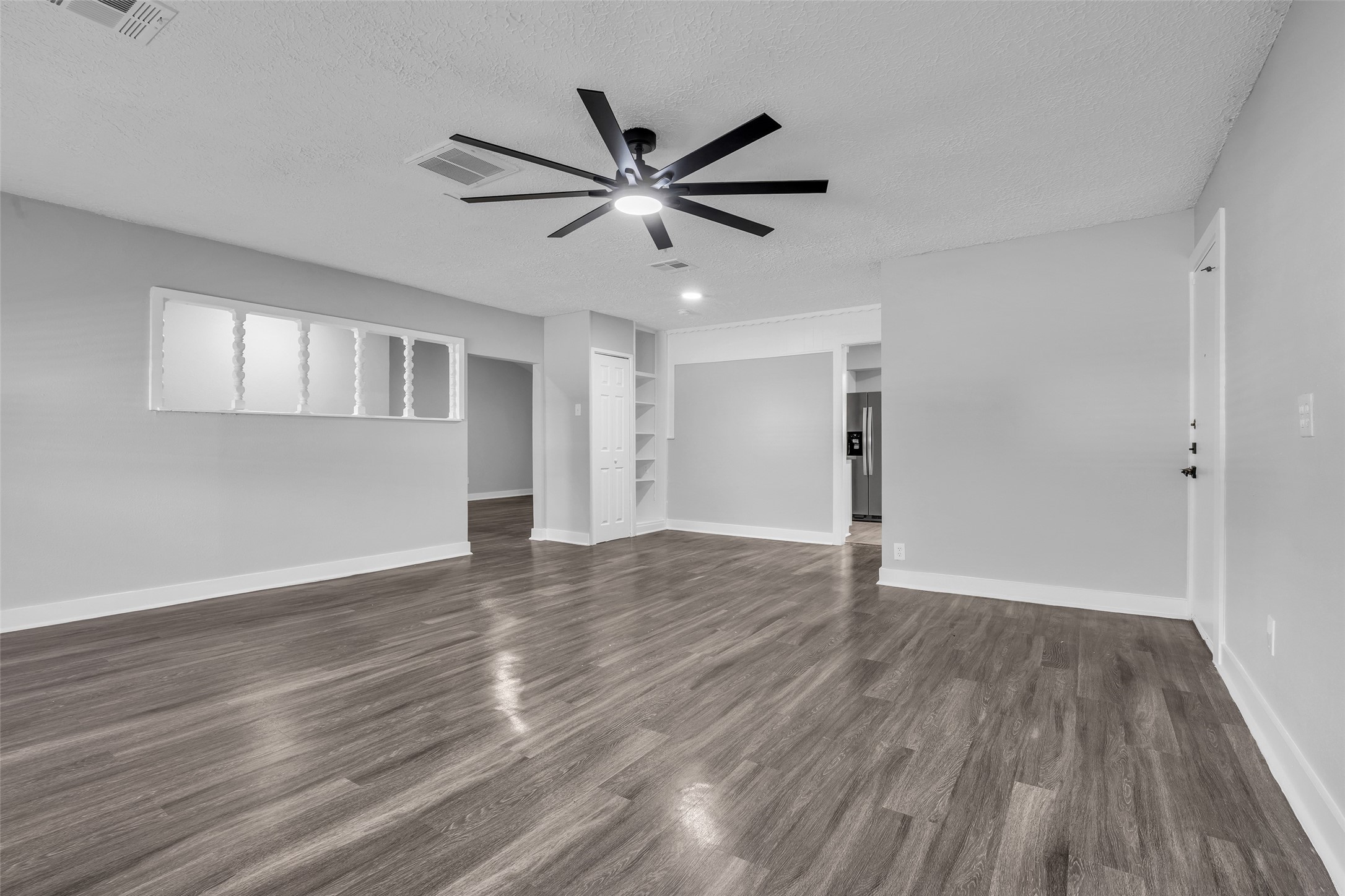 Decorative spindle pass-through windows keep the family room connected to the rest of the home.