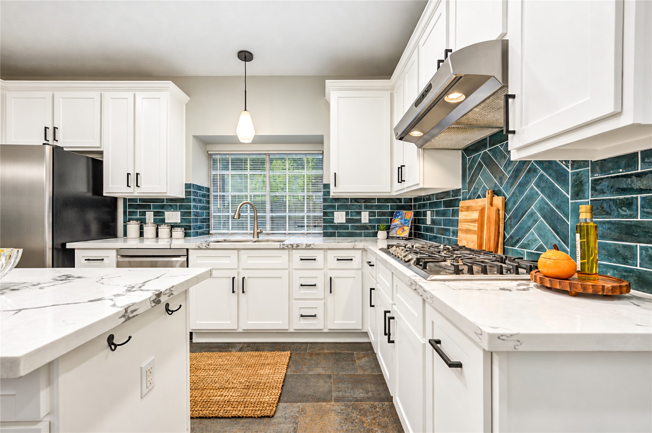 From quick morning coffees to preparing your favorite meals, this beautifully updated kitchen makes every moment a pleasure! Crisp white cabinetry, gleaming quartz countertops, stainless steel appliances and a stylish subway tile backsplash create a fresh, timeless space where cooking, conversation and everyday living come together effortlessly.