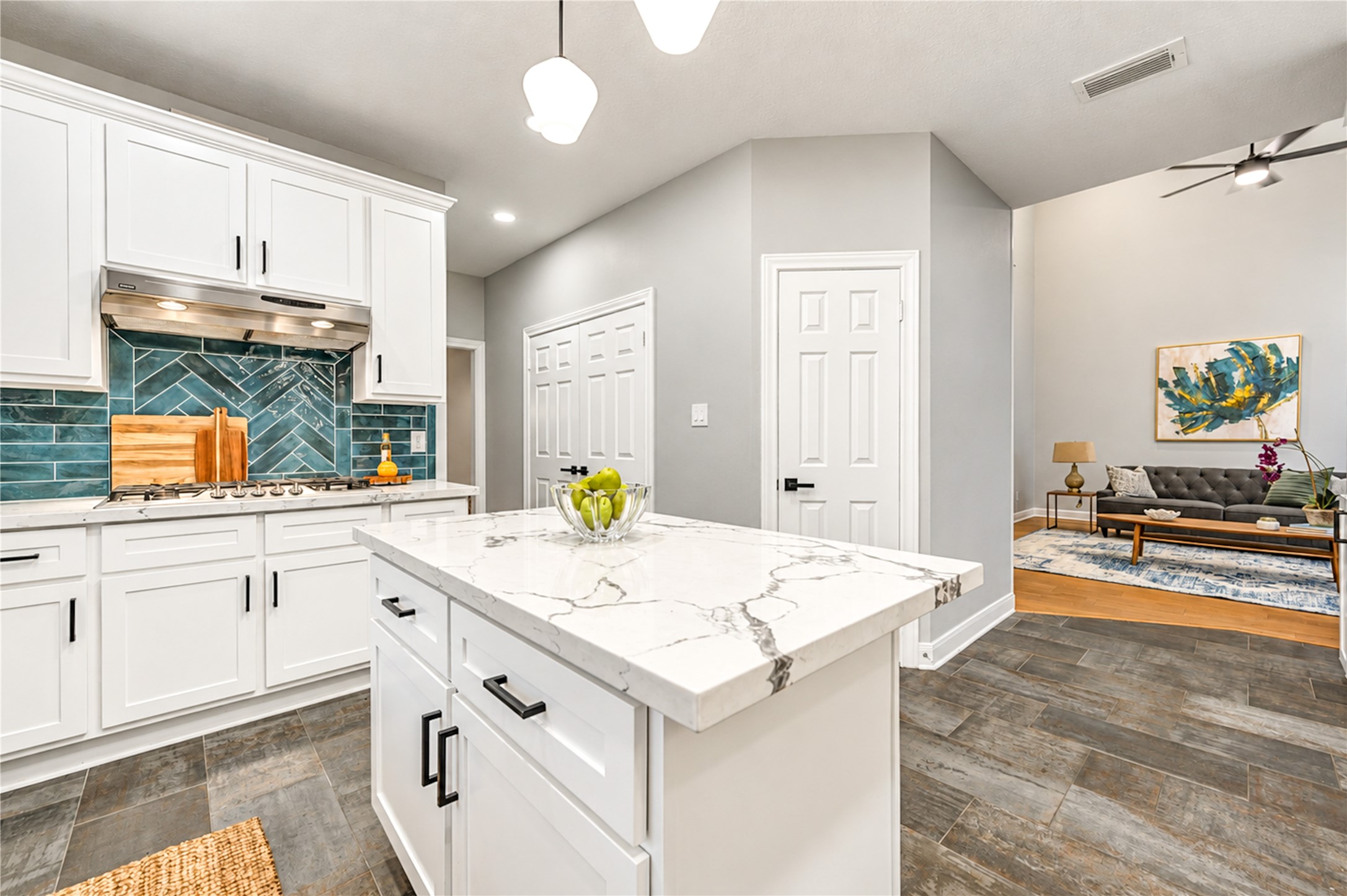 The heart of the home, where cooking and connection come together! This beautifully renovated kitchen features a spacious island, quartz countertops, stainless steel appliances and crisp white cabinetry. Open to the adjoining living space, it's perfect for preparing family favorites while staying connected to the conversation or hosting friends with ease!