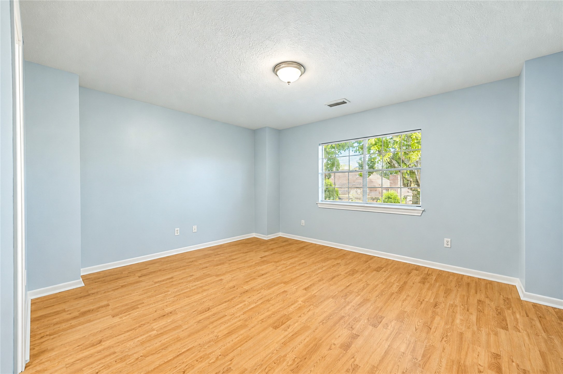 Bright, spacious and full of possibilities! This second upstairs bedroom features beautiful wood flooring, soft neutral tones and natural light, creating a welcoming space to relax and recharge. With plenty of room to personalize, it's ready to become a comfortable retreat that reflects your style!