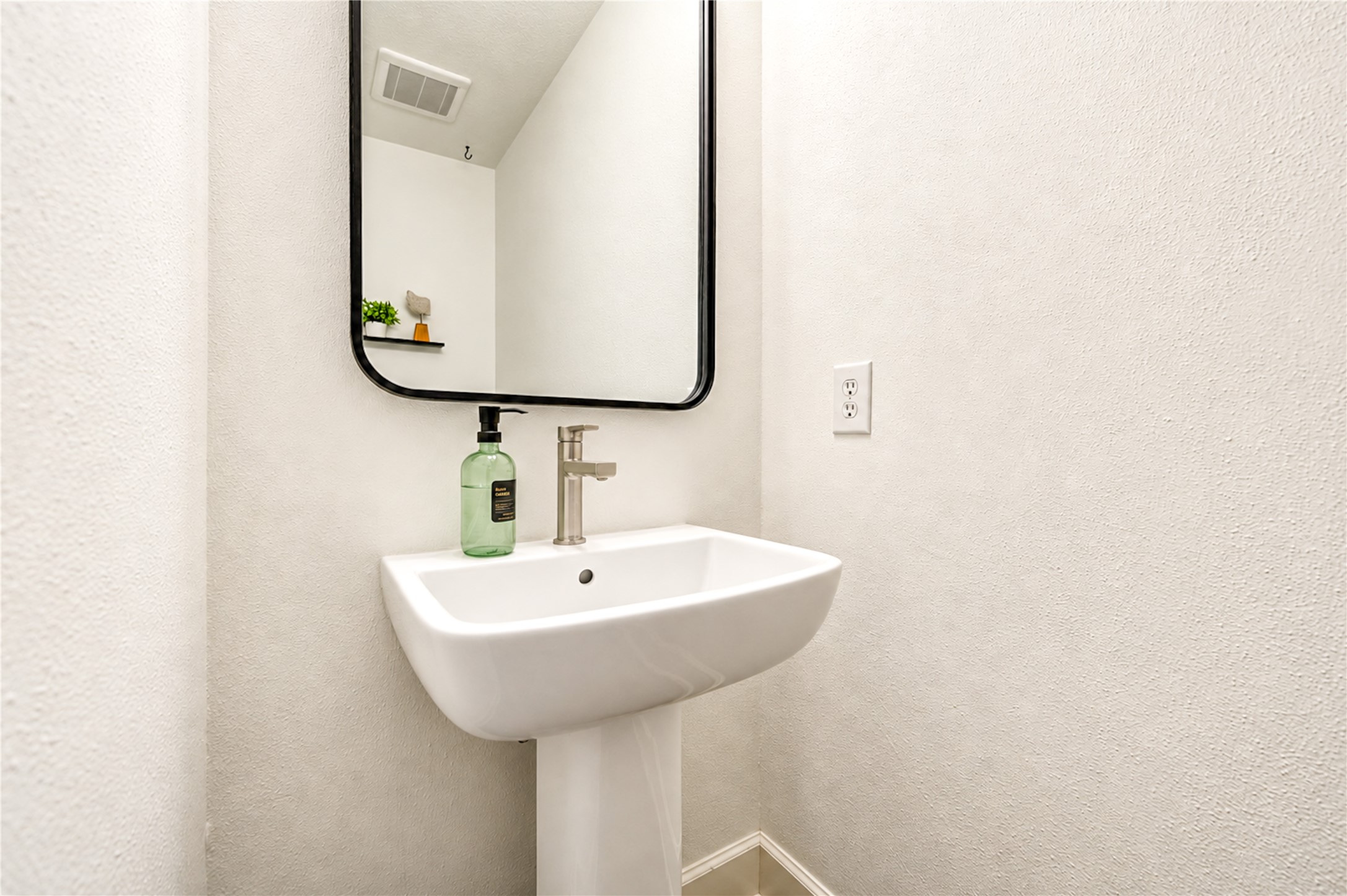 Thoughtfully designed for everyday convenience, this charming first-floor powder room offers a welcoming space for guests. Its clean, classic finishes and convenient location make entertaining effortless while adding comfort and functionality to the home.