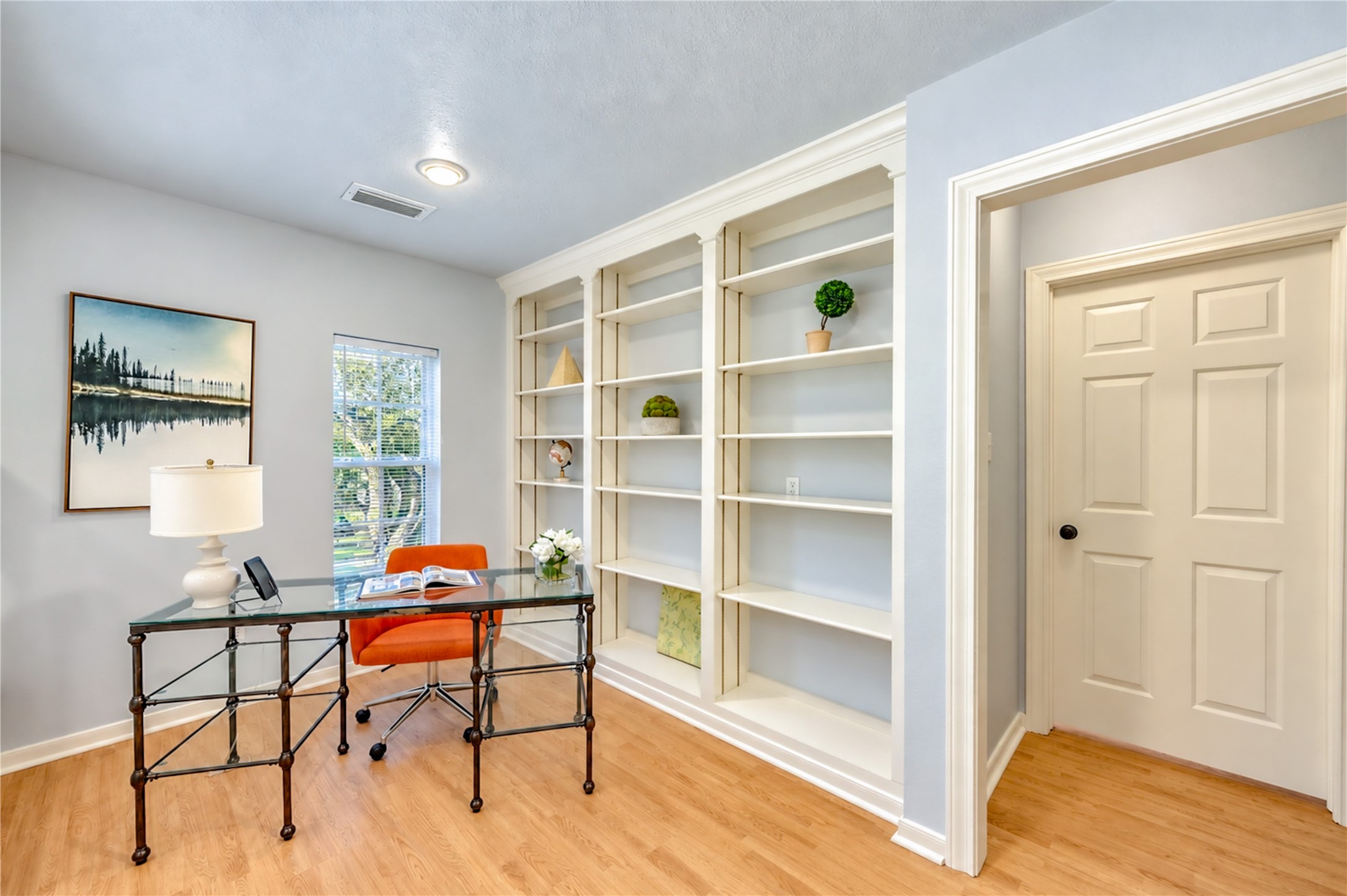 Your ideal work-from-home retreat awaits! This bright second-floor study features beautiful built-in shelving, warm wood floors and plenty of natural light, creating an inspiring space to work, read or pursue your passions. A peaceful escape designed for productivity and creativity!