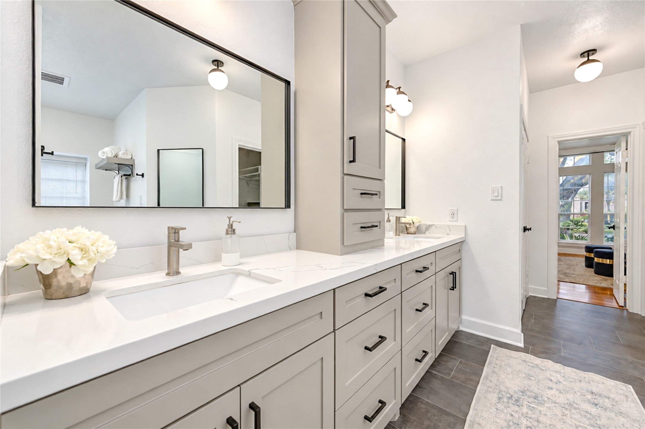 Indulge in a little everyday luxury in this beautifully renovated primary ensuite bath! Elegant quartz countertops, dual vanities and stylish modern finishes create a spa-inspired atmosphere, while the spacious layout makes morning routines effortless and evenings feel like a relaxing retreat.