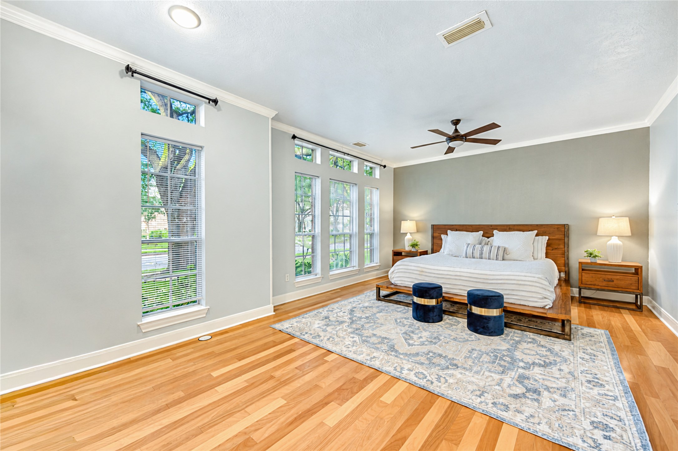 Retreat to your own private sanctuary in this spacious first-floor primary suite! Beautiful wood flooring, abundant natural light and peaceful views of the lush backyard create a soothing atmosphere. The perfect place to unwind after a busy day, enjoy a slow weekend morning and recharge in comfort and style.