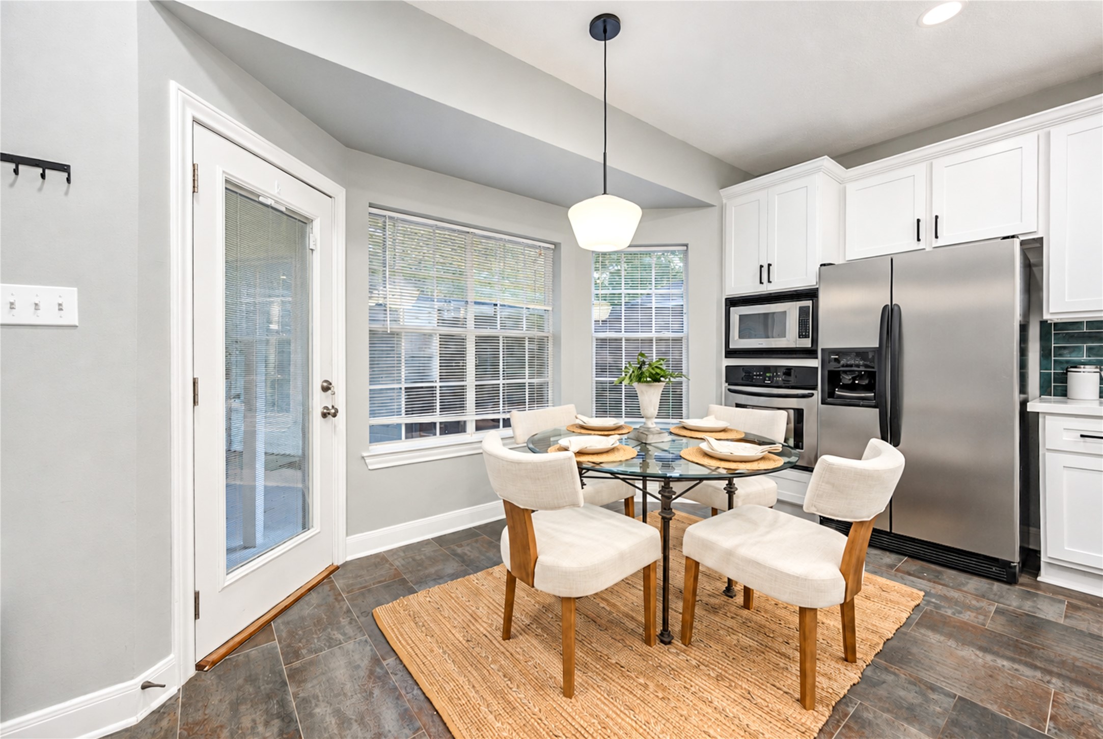 Start your mornings with a fresh cup of coffee and views of the backyard! This cheerful breakfast room is filled with natural light and offers the perfect spot for casual meals, weekend brunches and everyday conversations, with easy access to the kitchen and outdoor living space.