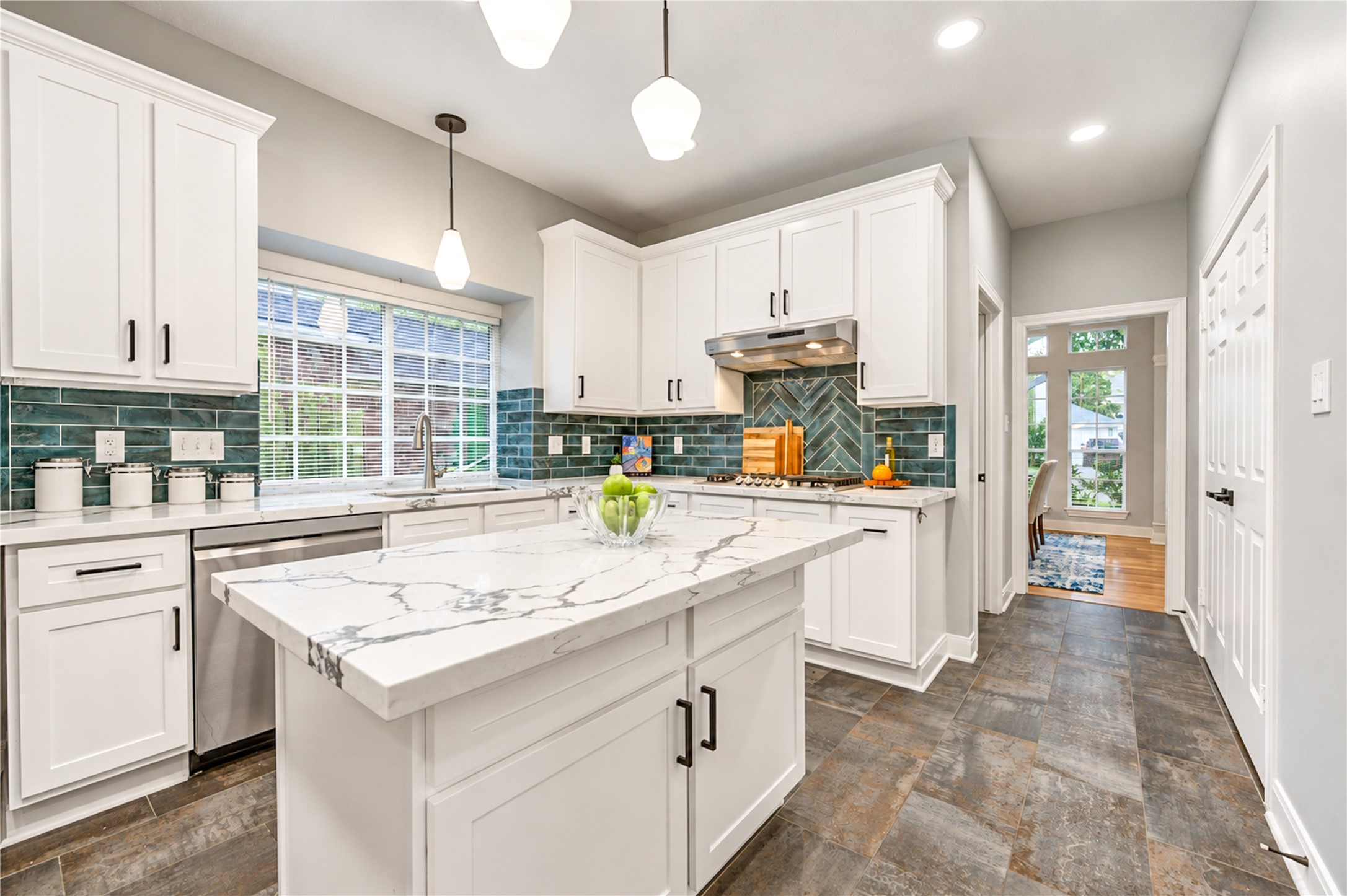 A kitchen designed for the way you live! The spacious center island invites everything from casual morning breakfasts to lively conversations while dinner is being prepared. Beautiful quartz countertops, crisp white cabinetry and modern finishes create a bright, welcoming space that makes cooking and entertaining a pleasure!