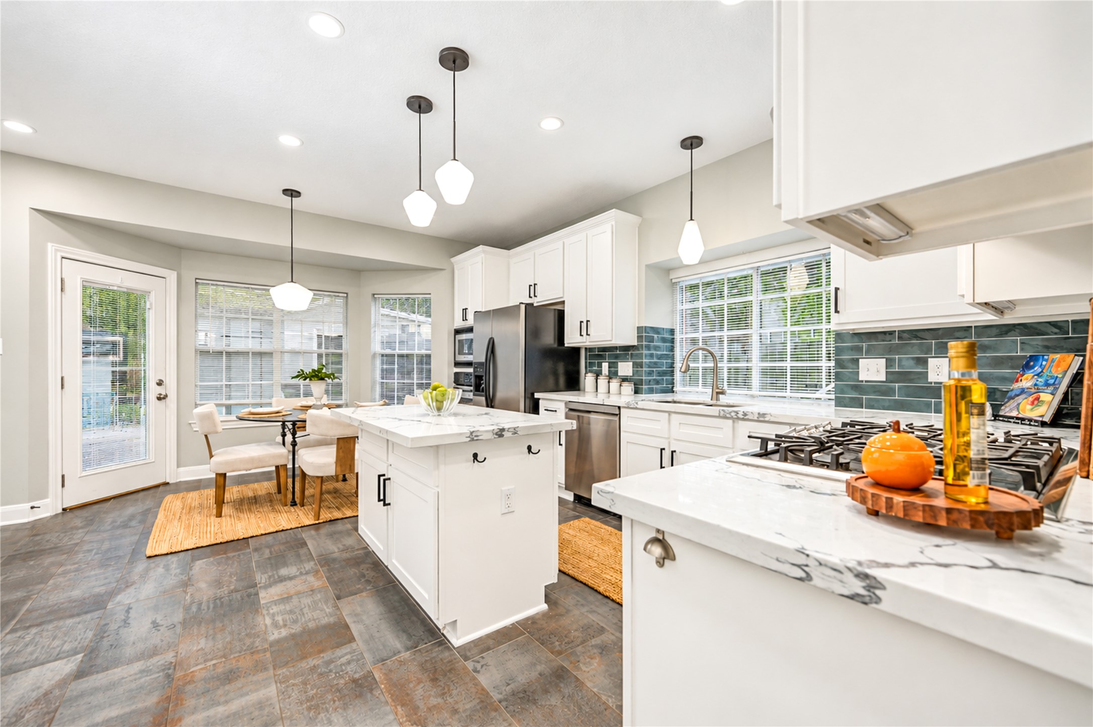 Designed for effortless everyday living and entertaining! This beautifully renovated kitchen opens to a light-filled breakfast area, creating a welcoming space to enjoy morning coffee, casual meals and lively conversations. With its spacious island, modern finishes and easy flow, it's a place where everyone will love to gather!