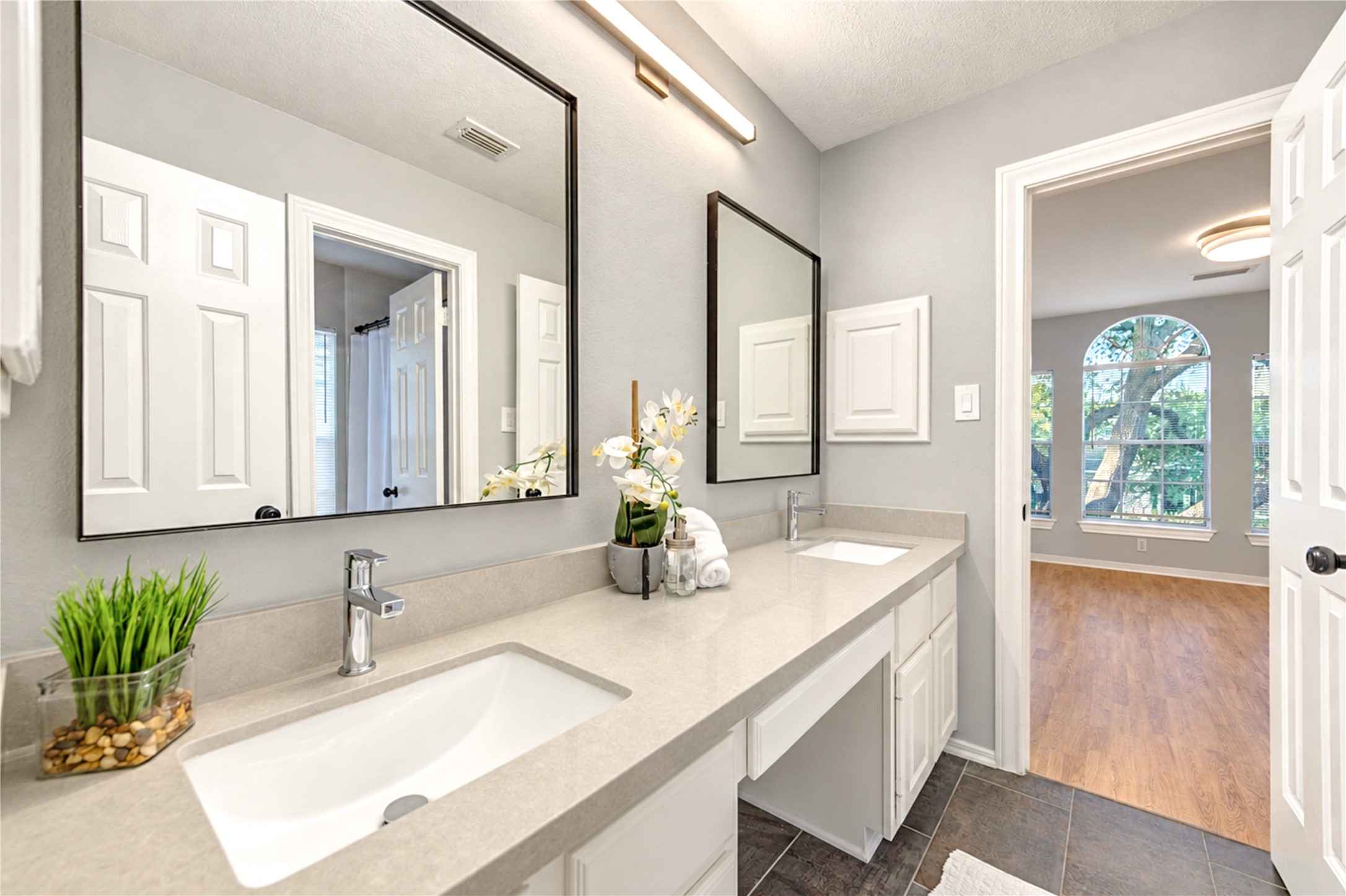 Style meets everyday convenience in this beautifully renovated Hollywood bathroom! Connecting two upstairs bedrooms, the spacious dual-sink vanity with elegant quartz countertops makes busy mornings effortless, while sleek fixtures and fresh, modern finishes create a bright, inviting space designed for comfort and functionality.
