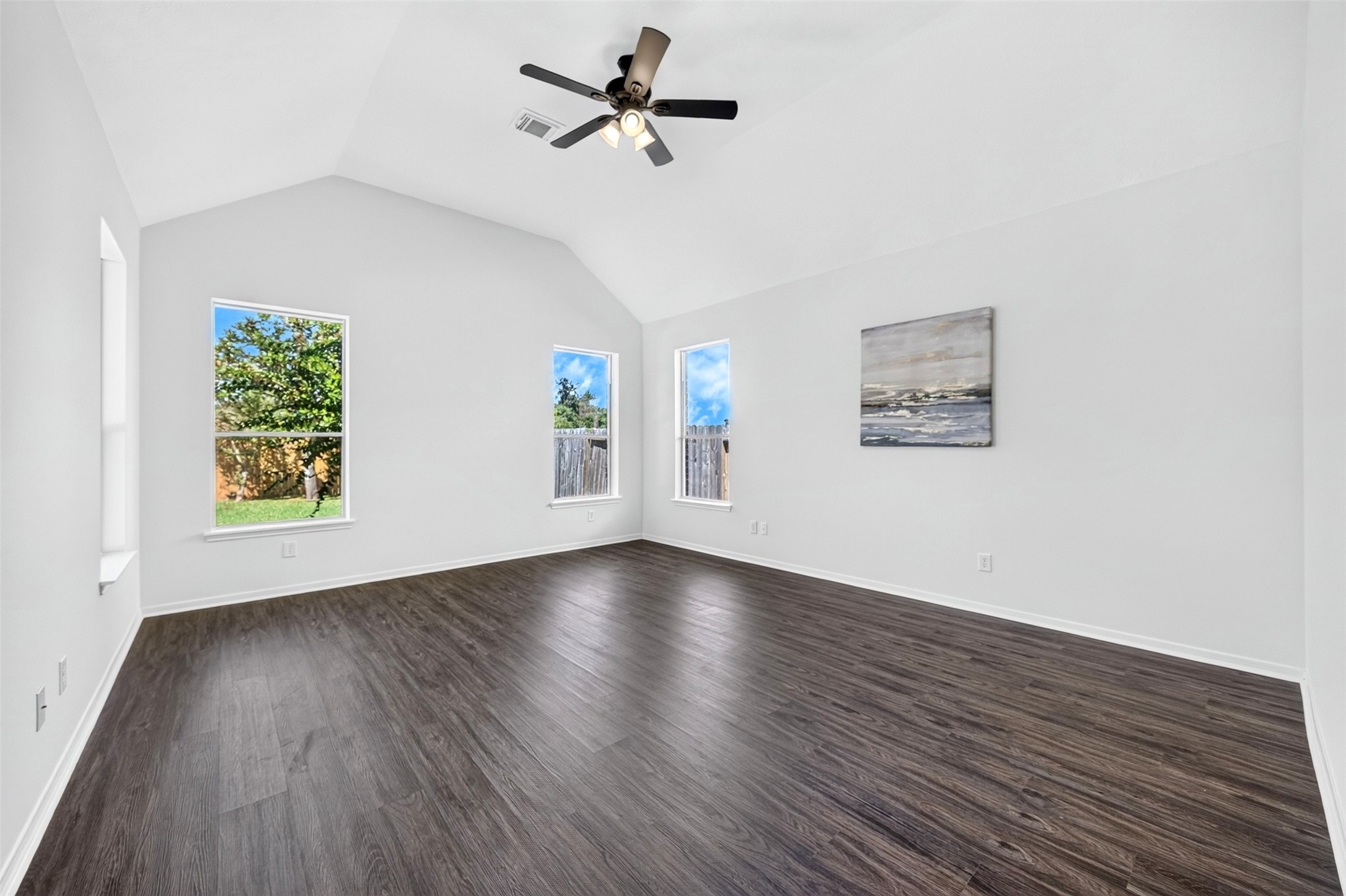 Spacious and bright master bedroom with high ceilings and 4 windows that offer plenty of natural light.