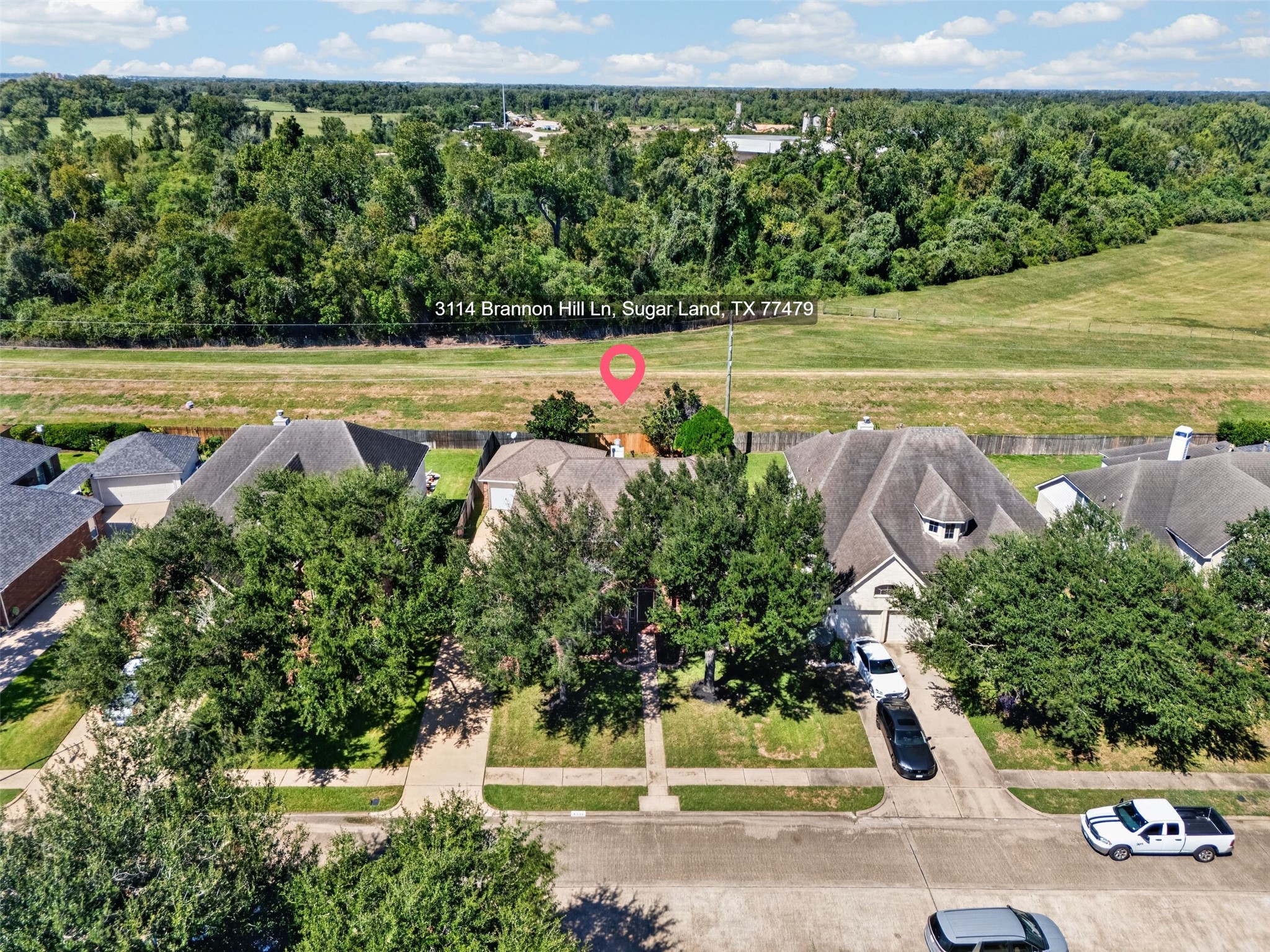 Charming home nestled in a serene neighborhood, surrounded by lush greenery and offering peaceful views of expansive open fields.