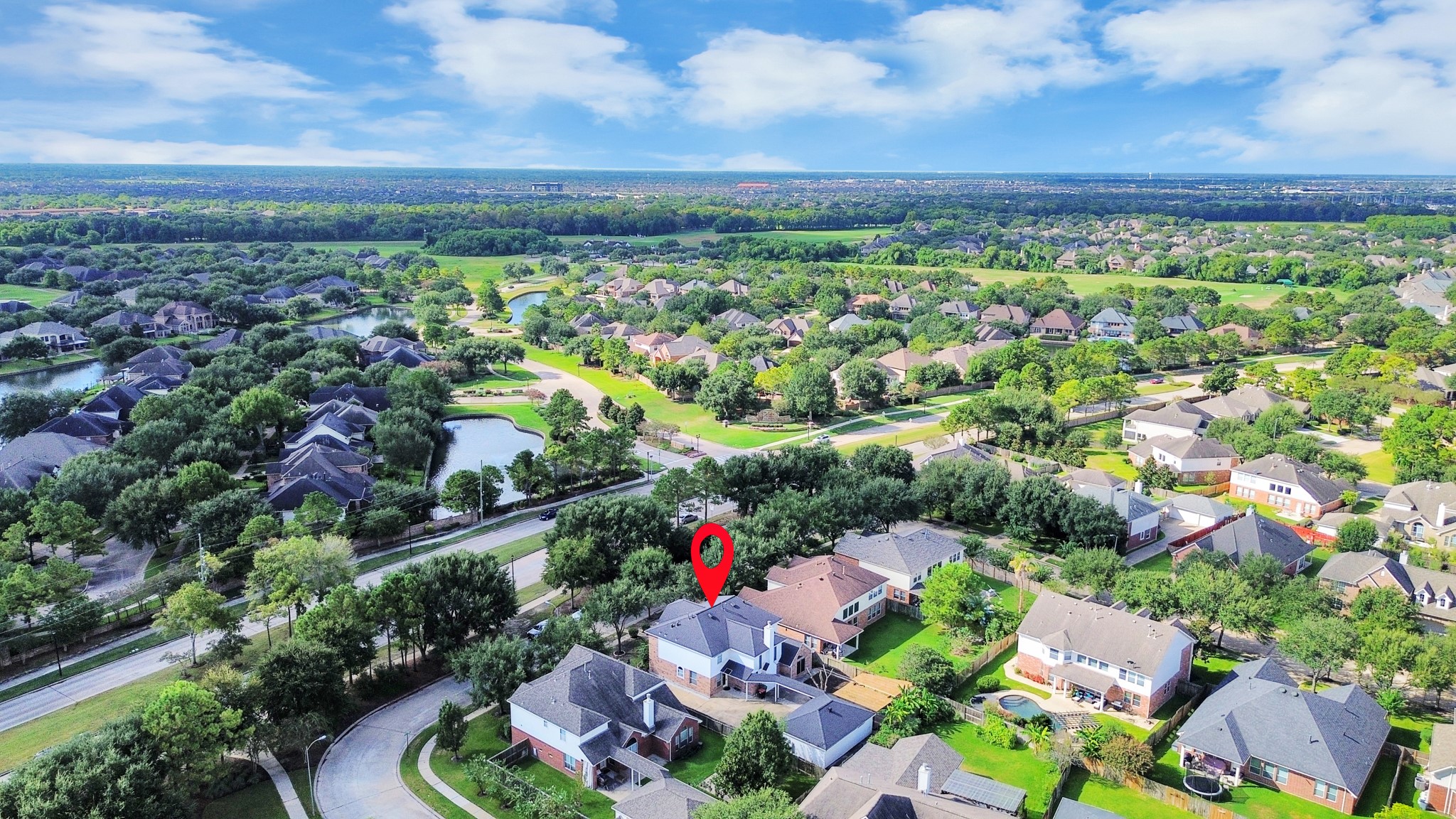 Charming suburban home nestled in a lush, green neighborhood with picturesque views of nearby lakes and parks.