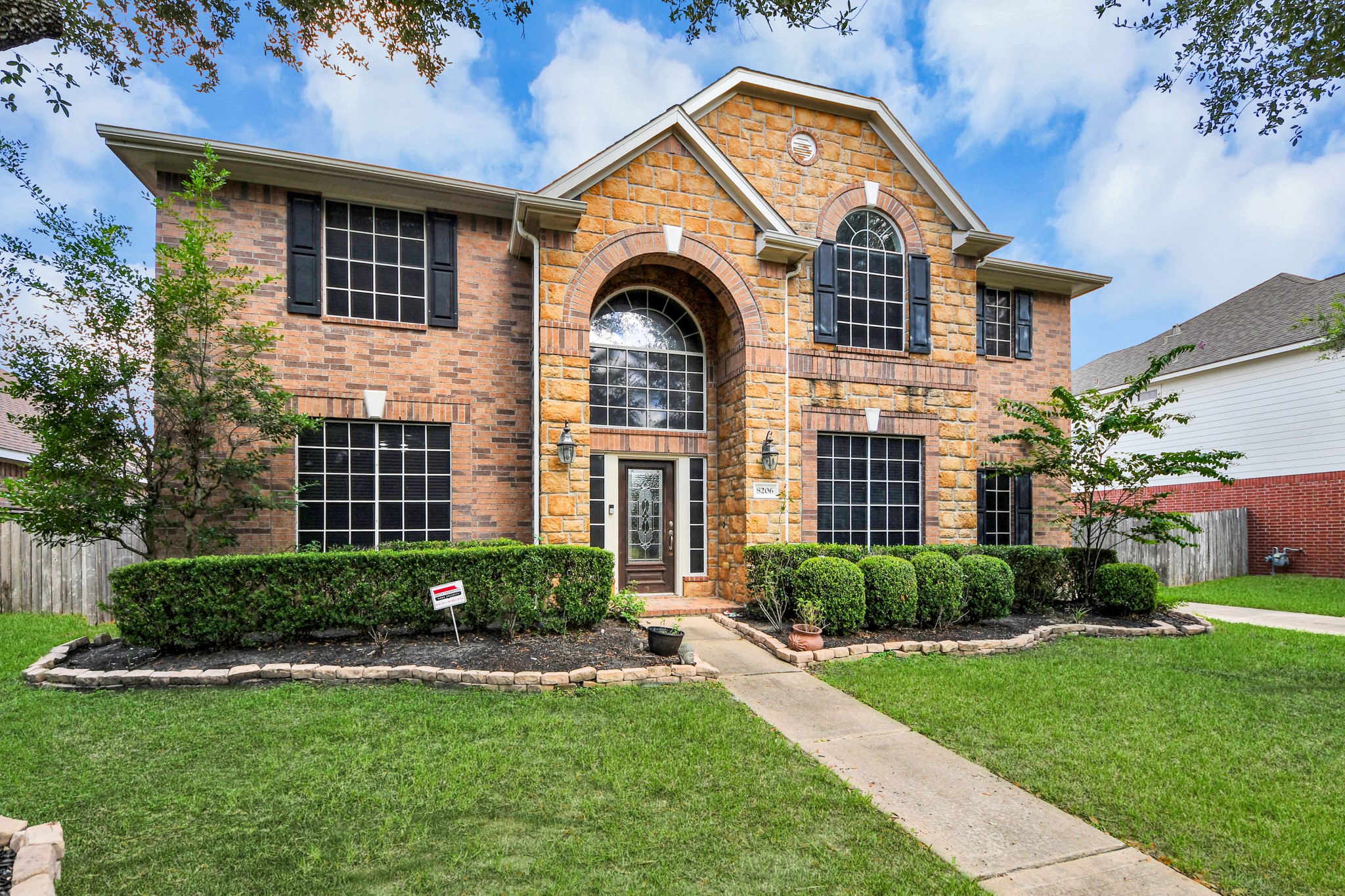 Stunning two-story home with a blend of brick and stone facade, featuring a grand entrance, manicured landscaping, and large windows for abundant natural light. Stunning two-story home with a blend of brick and stone facade, featuring a grand entrance, manicured landscaping, and large windows for abundant natural light.