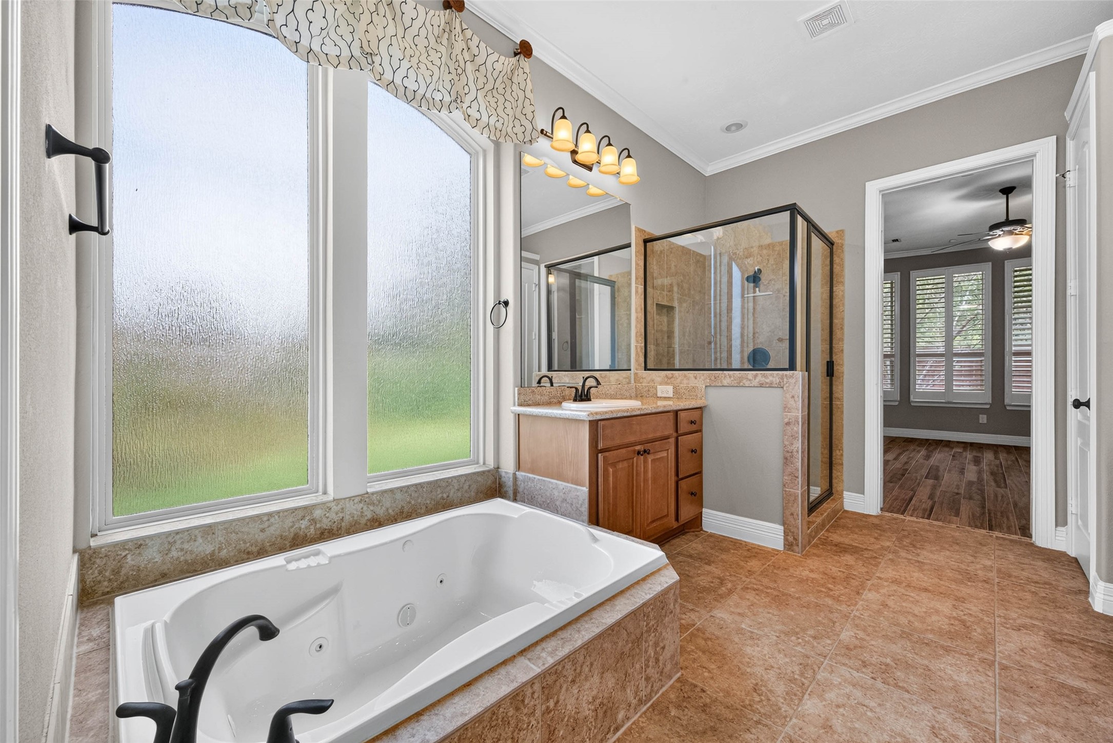 This primary bathroom features a modern soaking tub and a separate walk-in shower