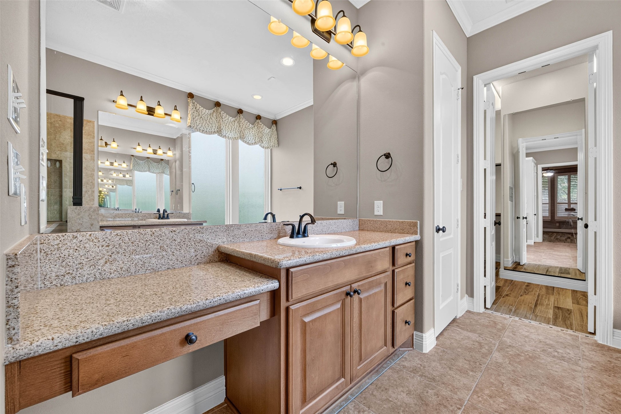 Primary bathroom featuring dual sinks and a dedicated vanity area