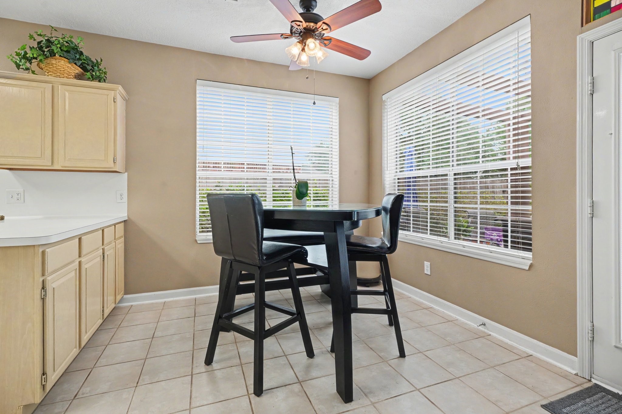 Breakfast room with views of the landscaping and pool.