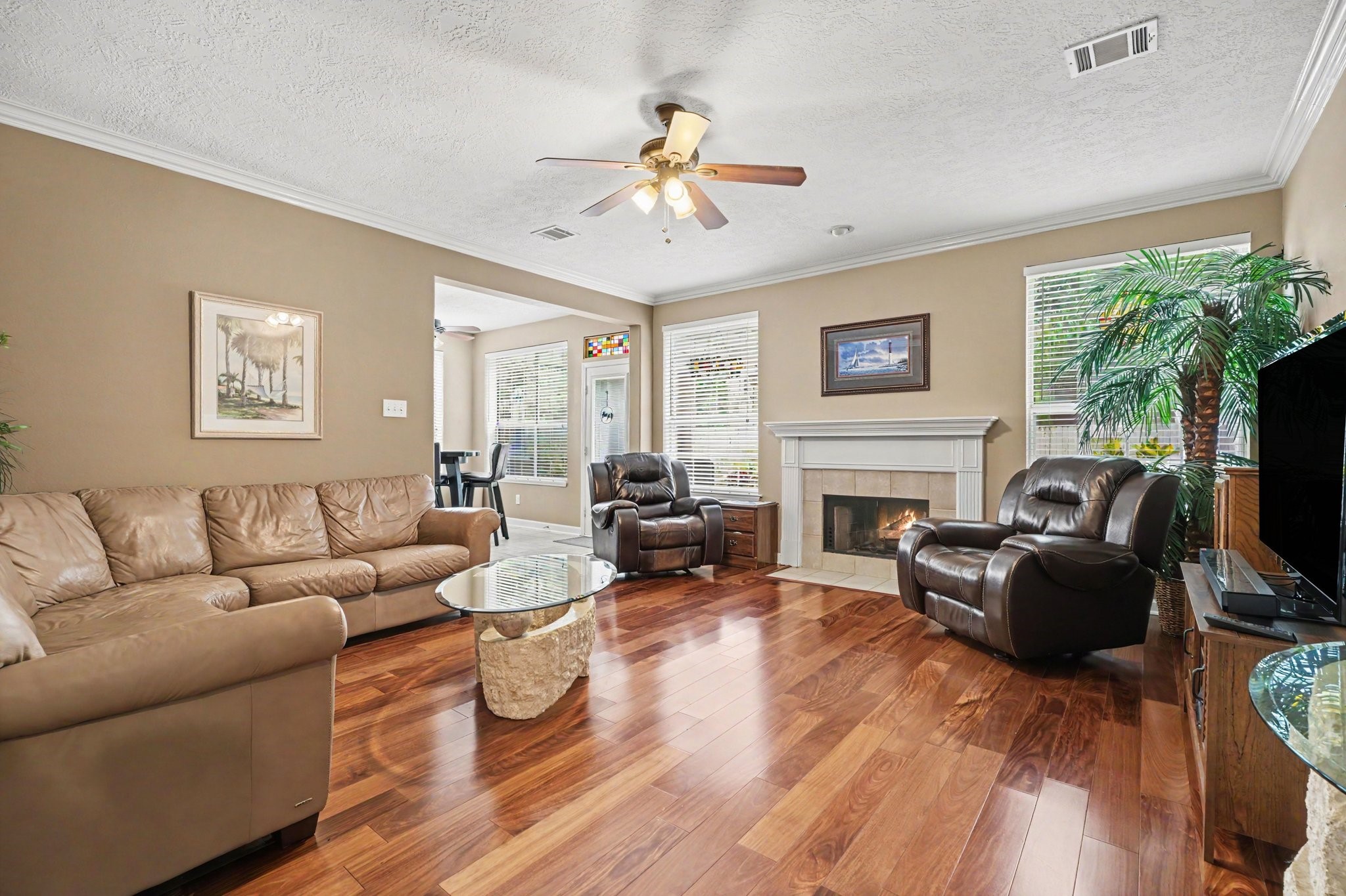 Living room off of kitchen and breakfast area with beautiful wood floors and fireplace.