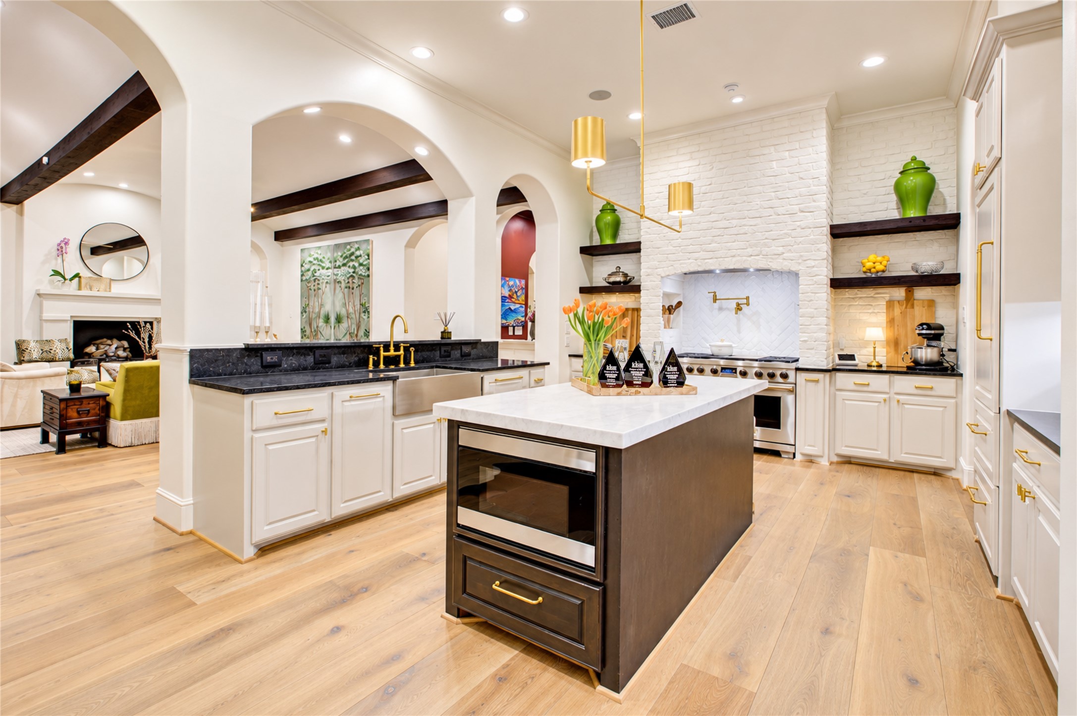Elevated kitchen finishes include a herringbone brick cooking surround, soft-close cabinetry, and a Sharp microwave drawer in the island.